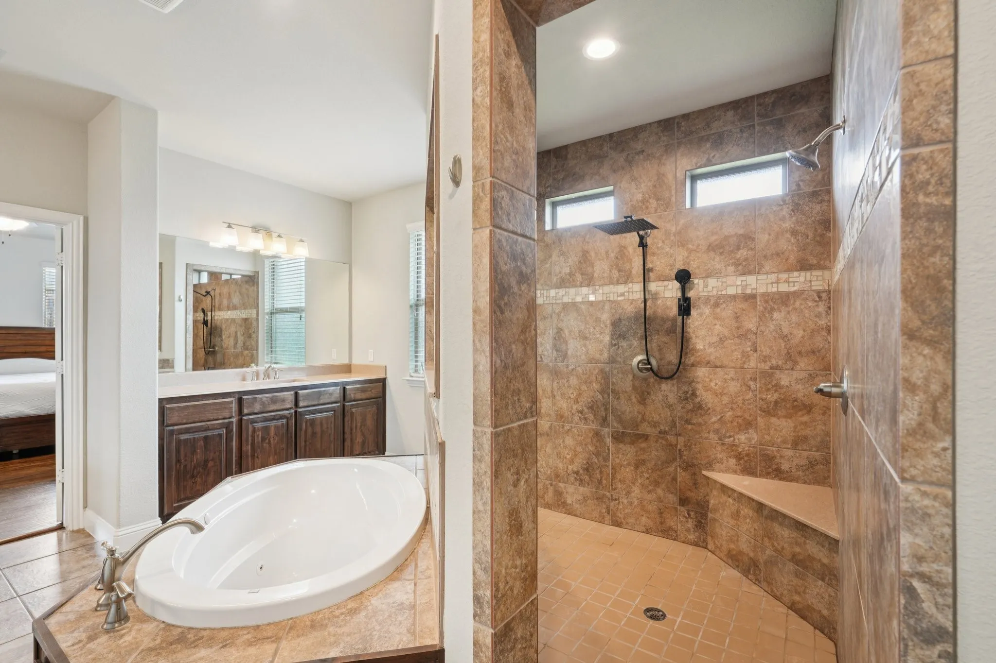 Primary bathroom featuring a walk-through shower with dual shower heads.