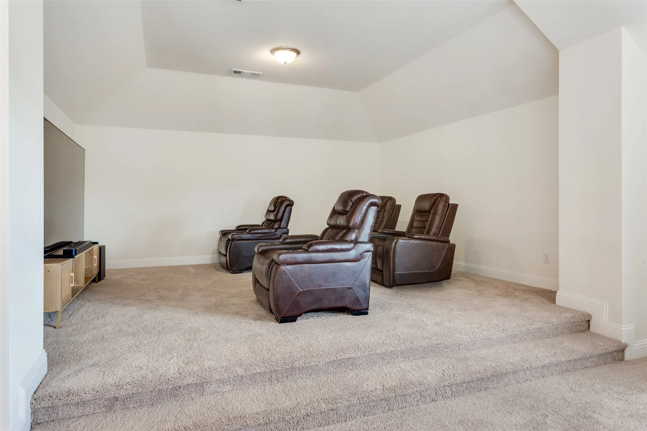 Sitting room featuring light colored carpet and lofted ceiling