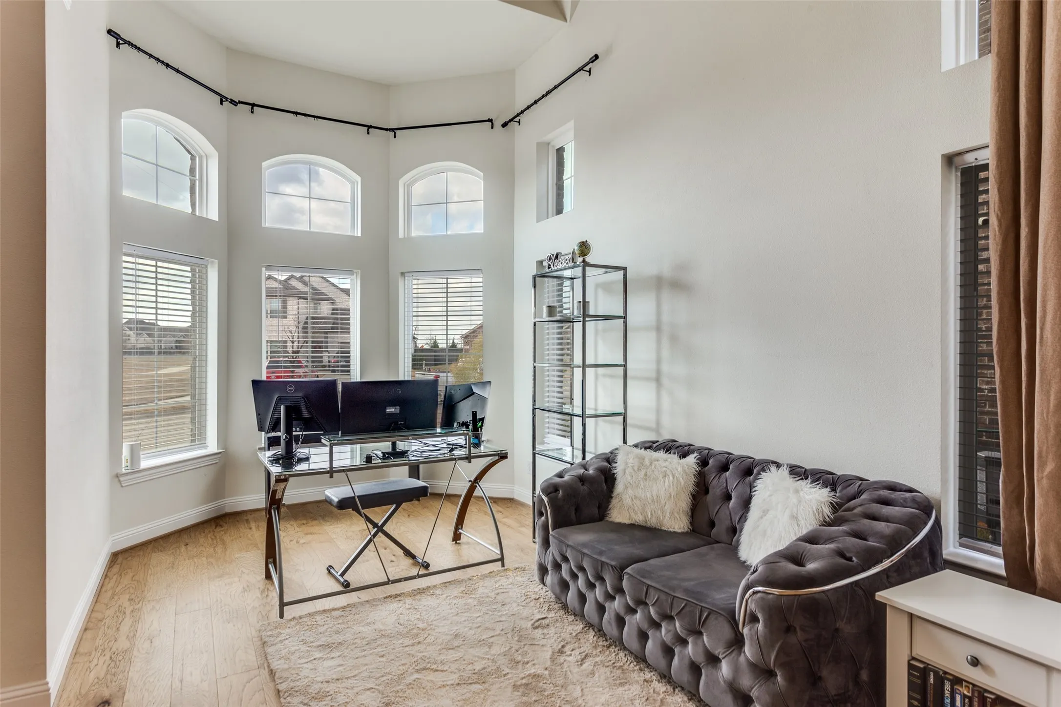 Office space featuring a high ceiling and light wood-style flooring