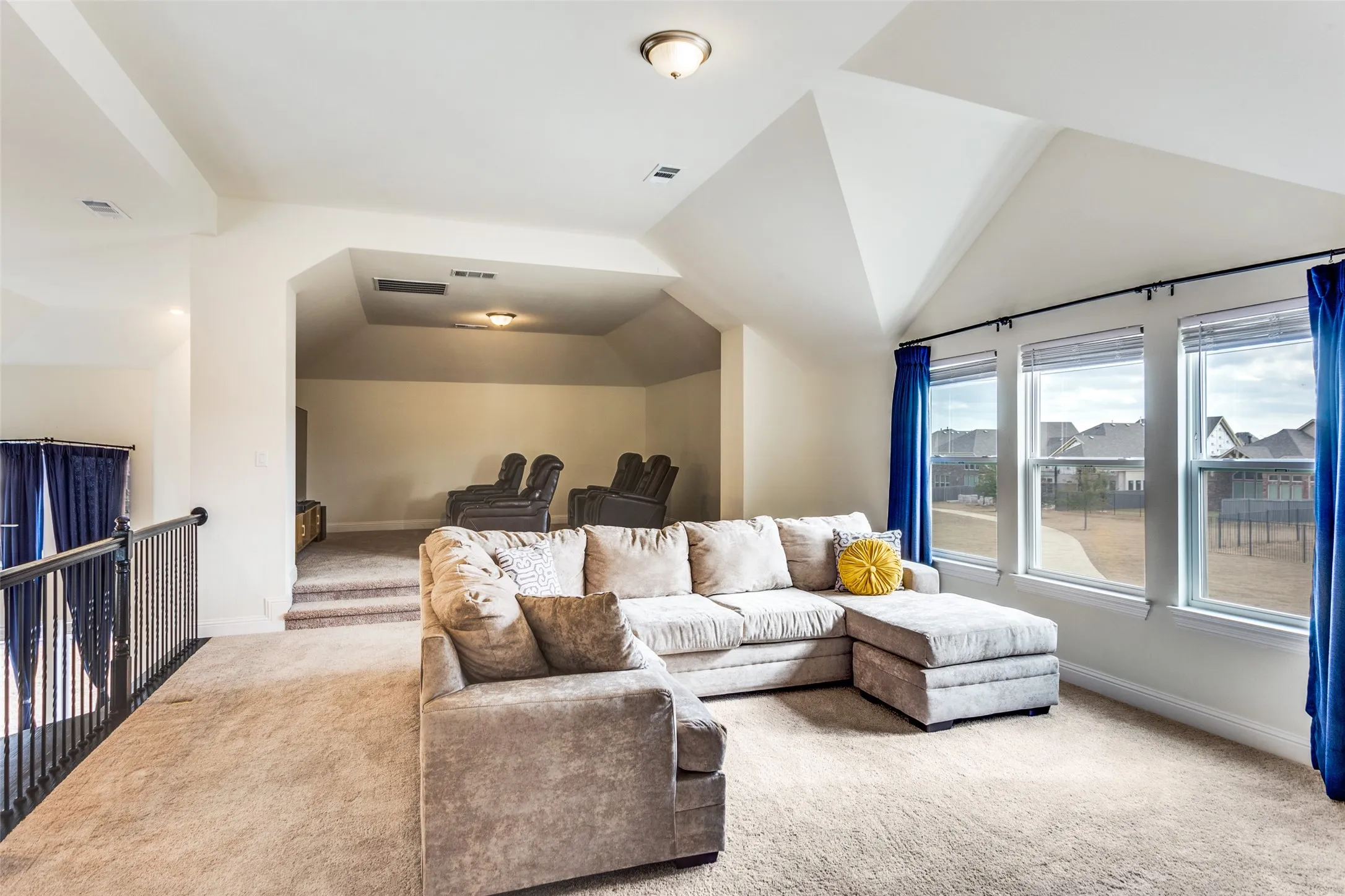 Living room with lofted ceiling and carpet flooring