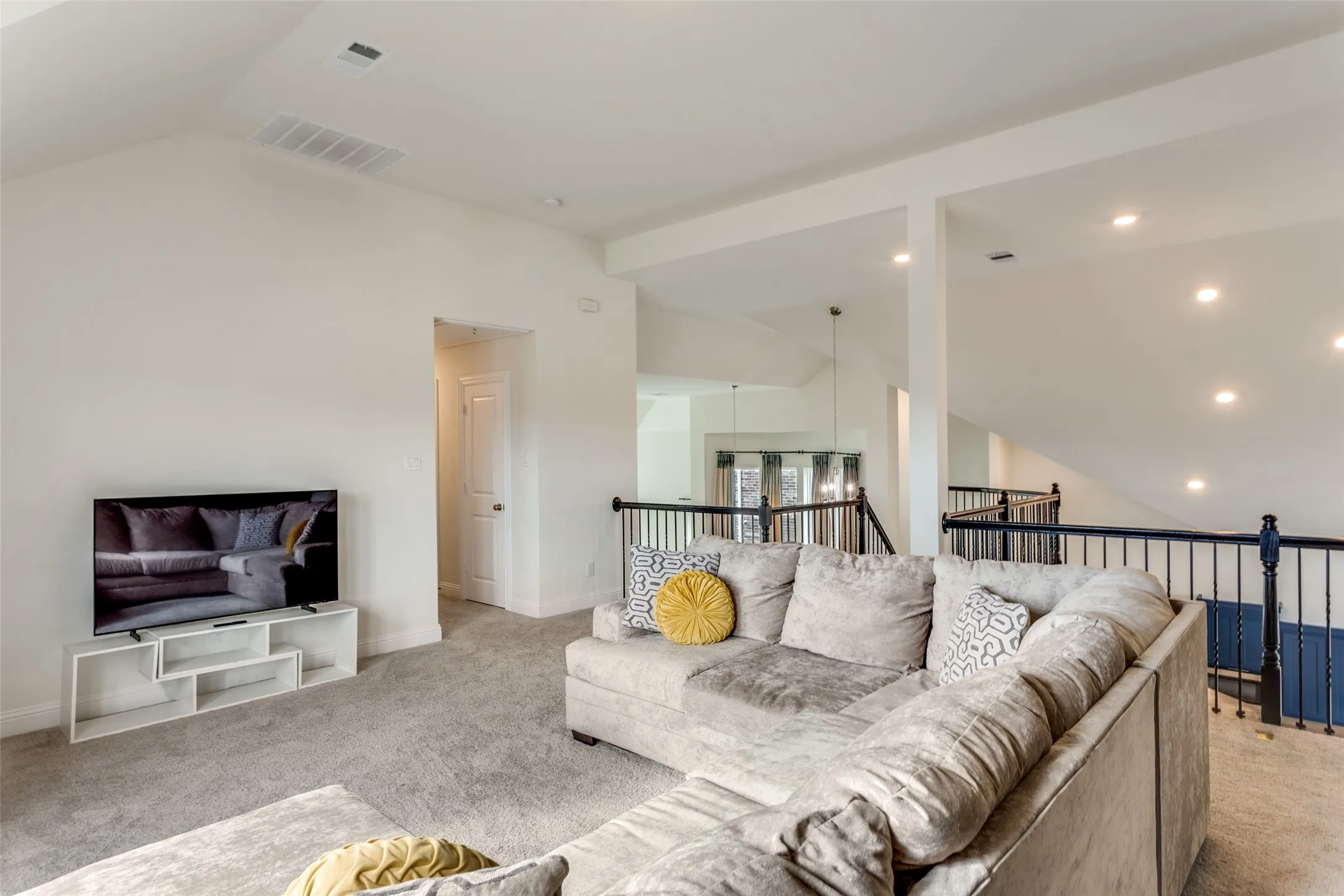 Living area featuring light colored carpet and baseboards