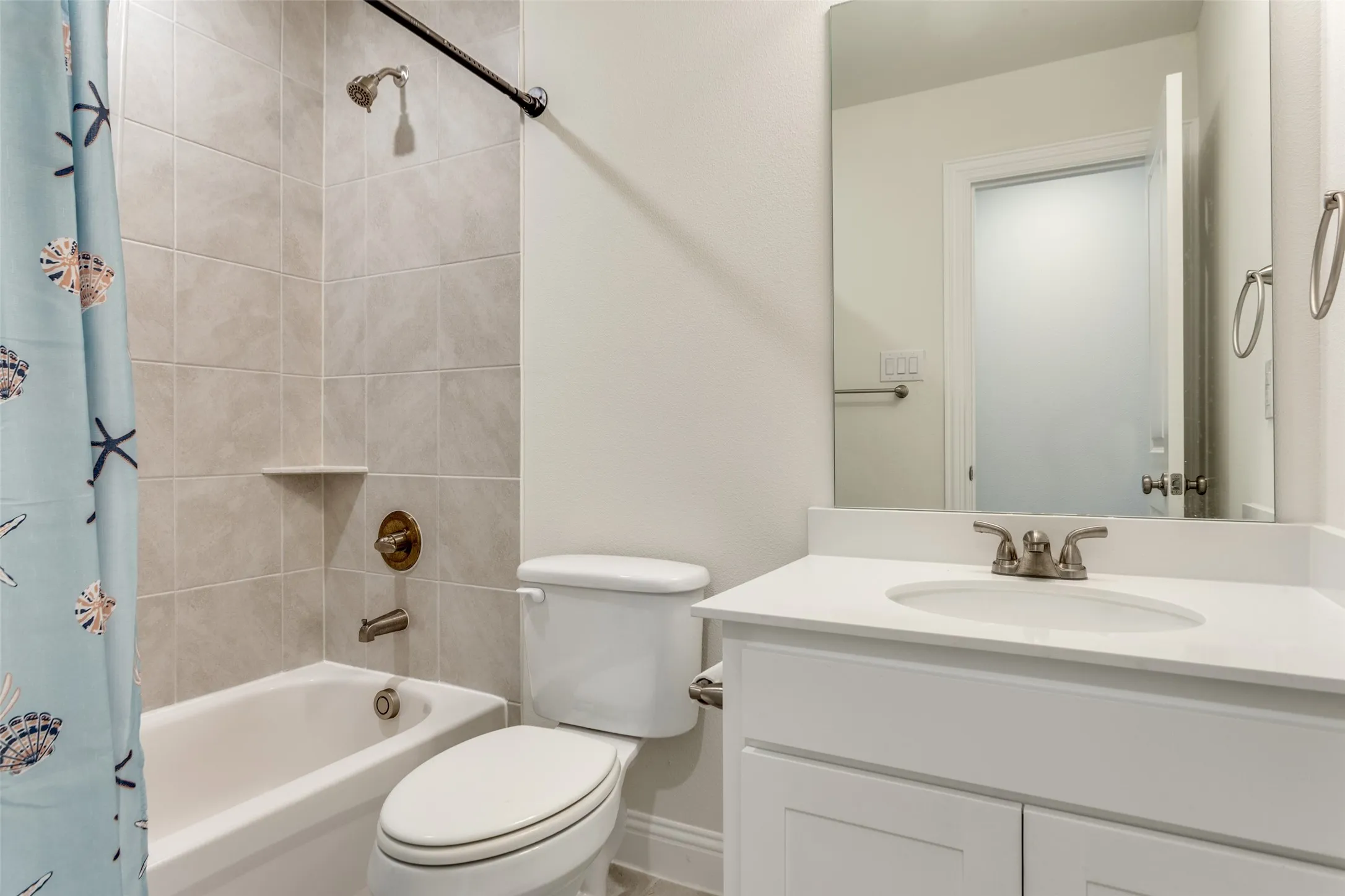 Bathroom with vanity and shower / tub combo