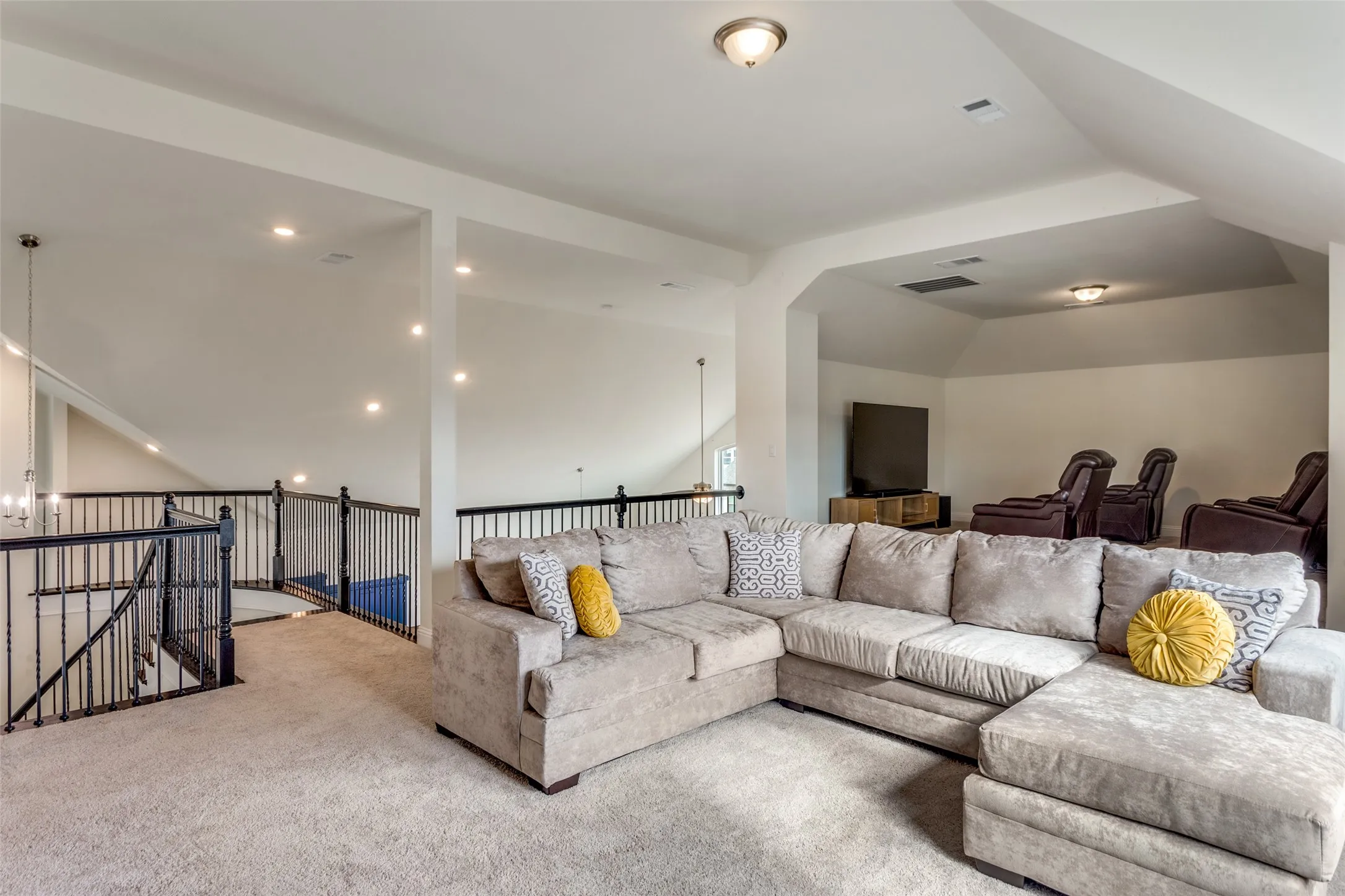 Living room featuring carpet floors, vaulted ceiling, and a chandelier