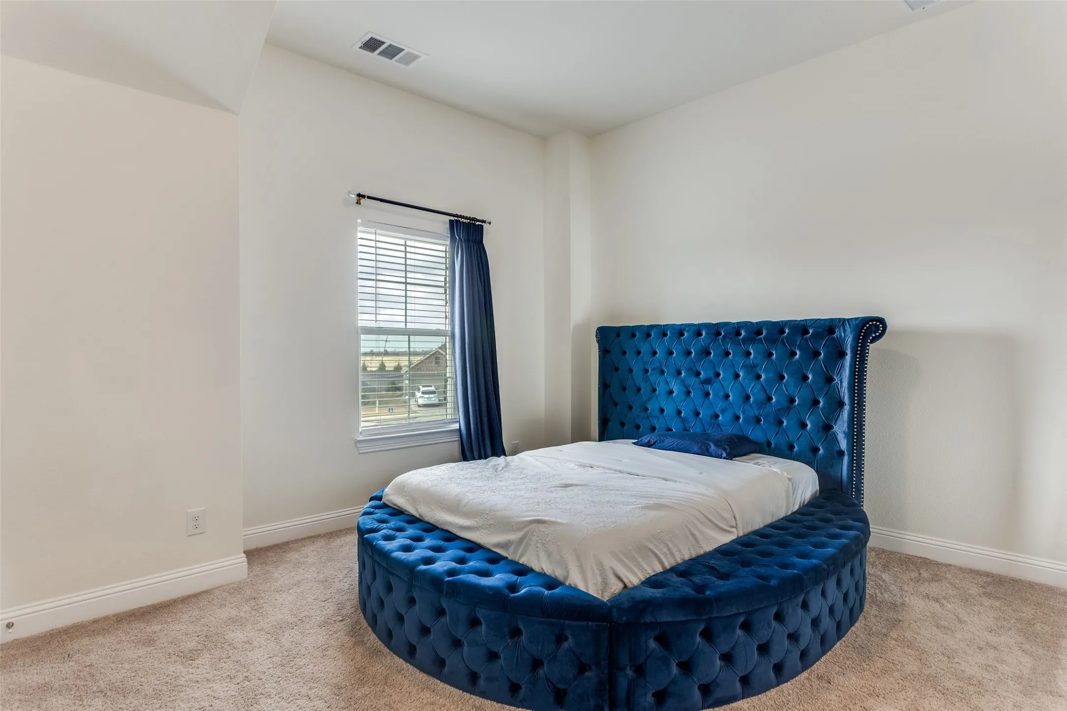 Bedroom featuring light carpet