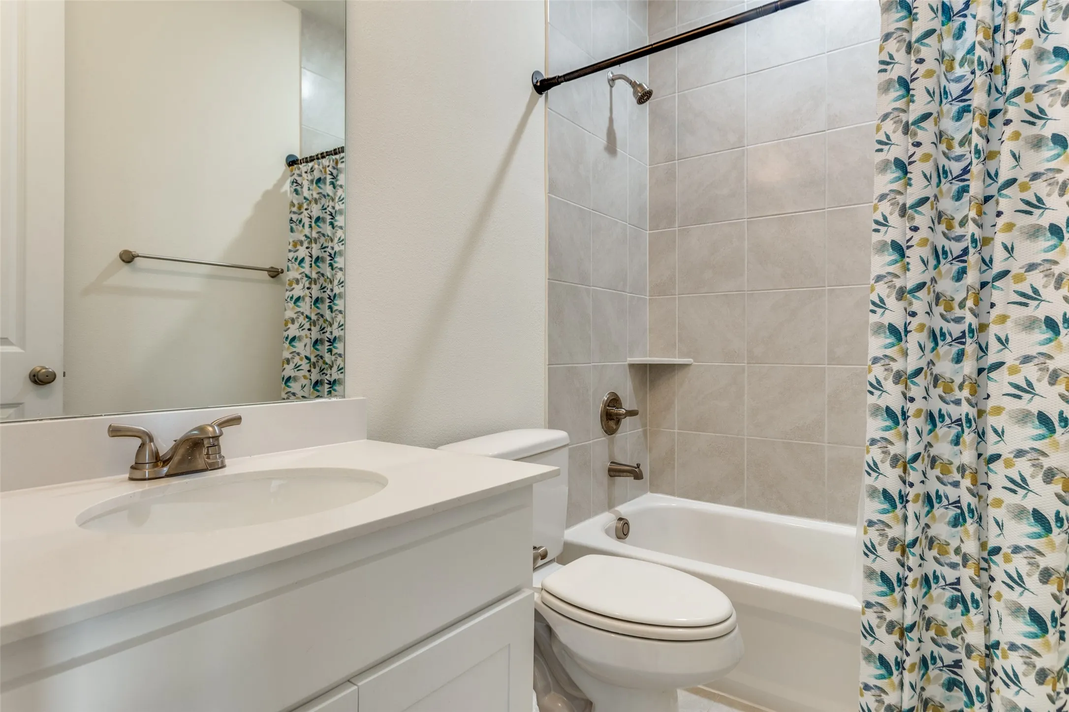 Bathroom featuring vanity and shower / tub combo