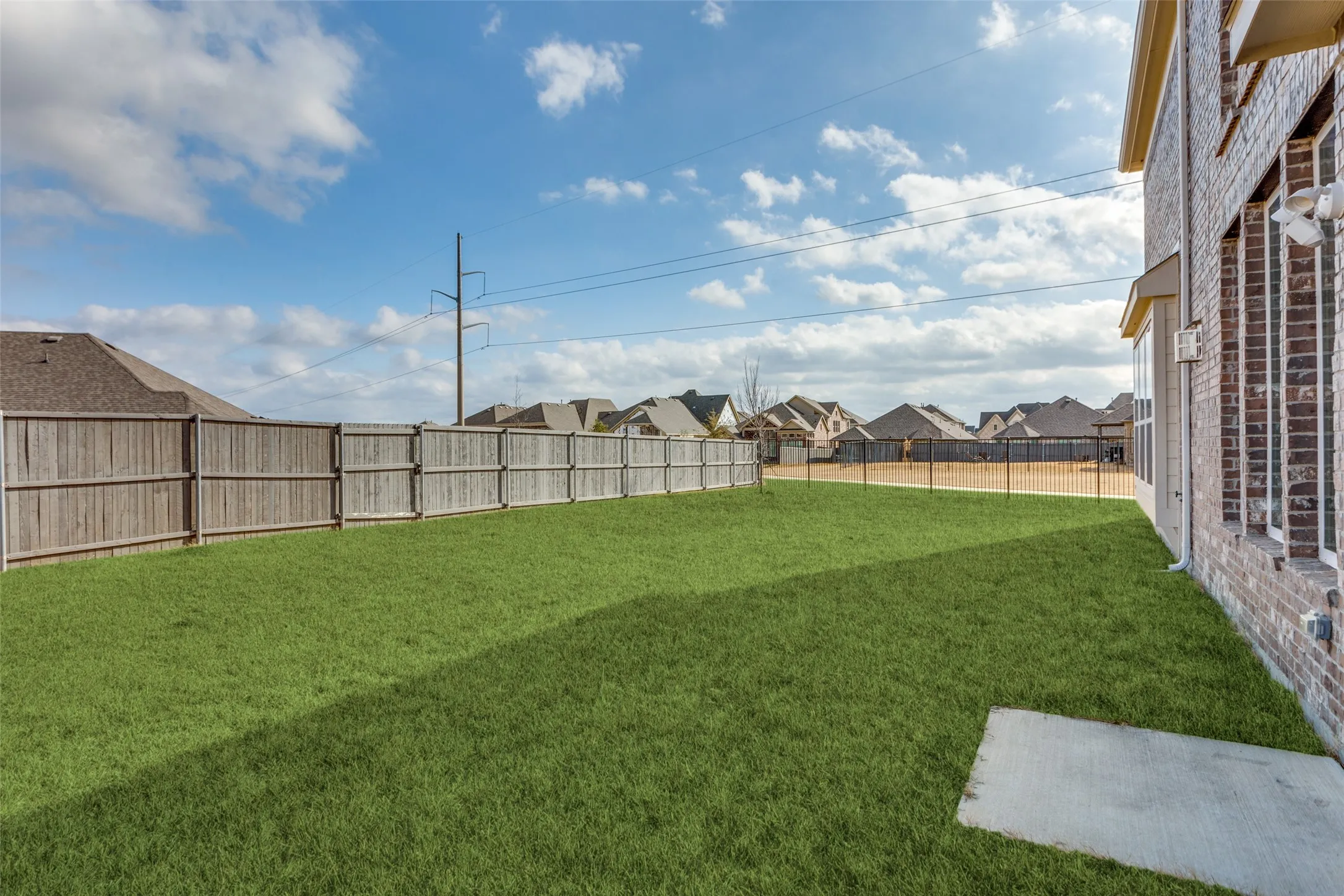 Fenced backyard with a residential view
