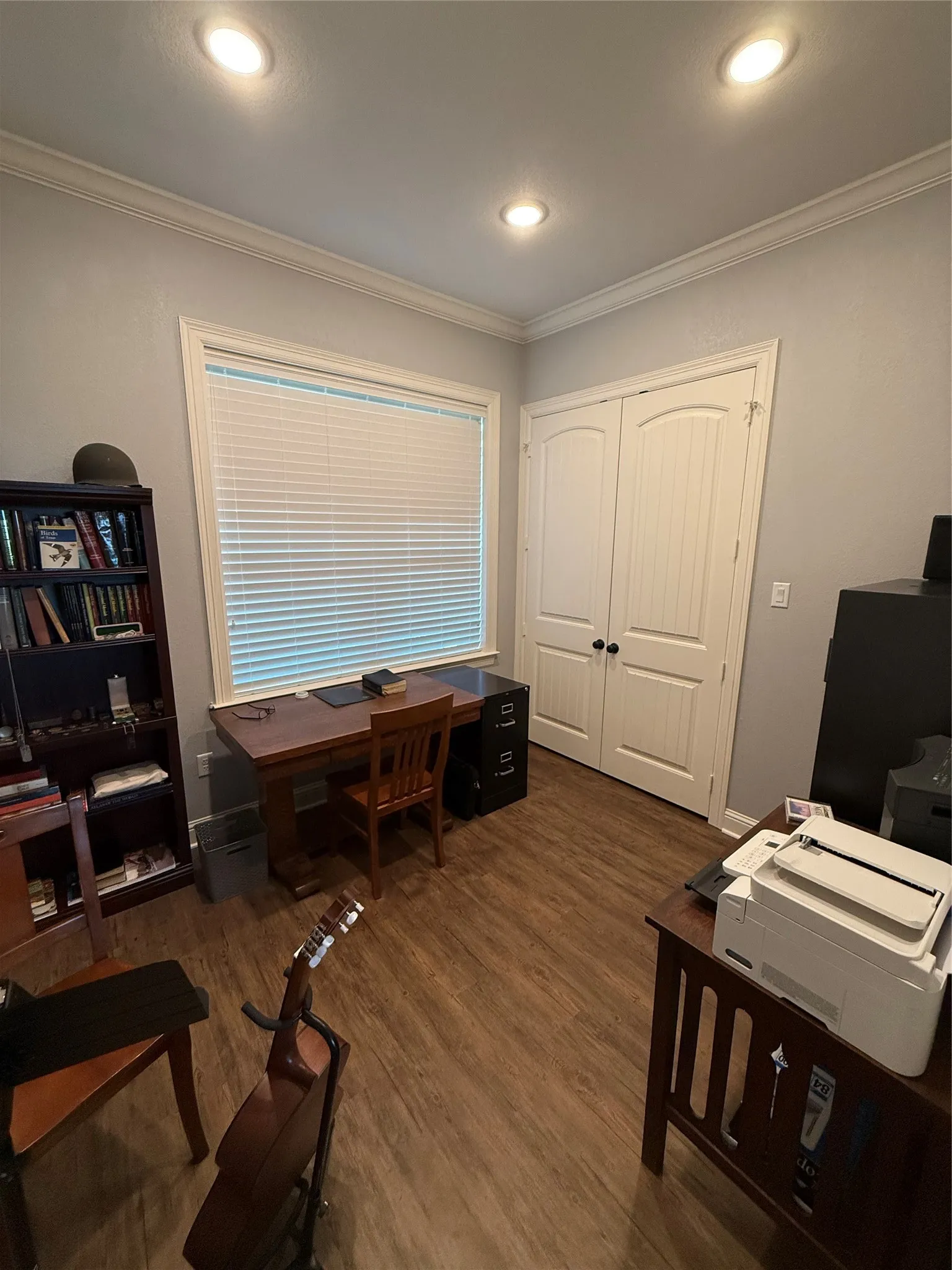 Home office featuring crown molding, wood finished floors, and recessed lighting