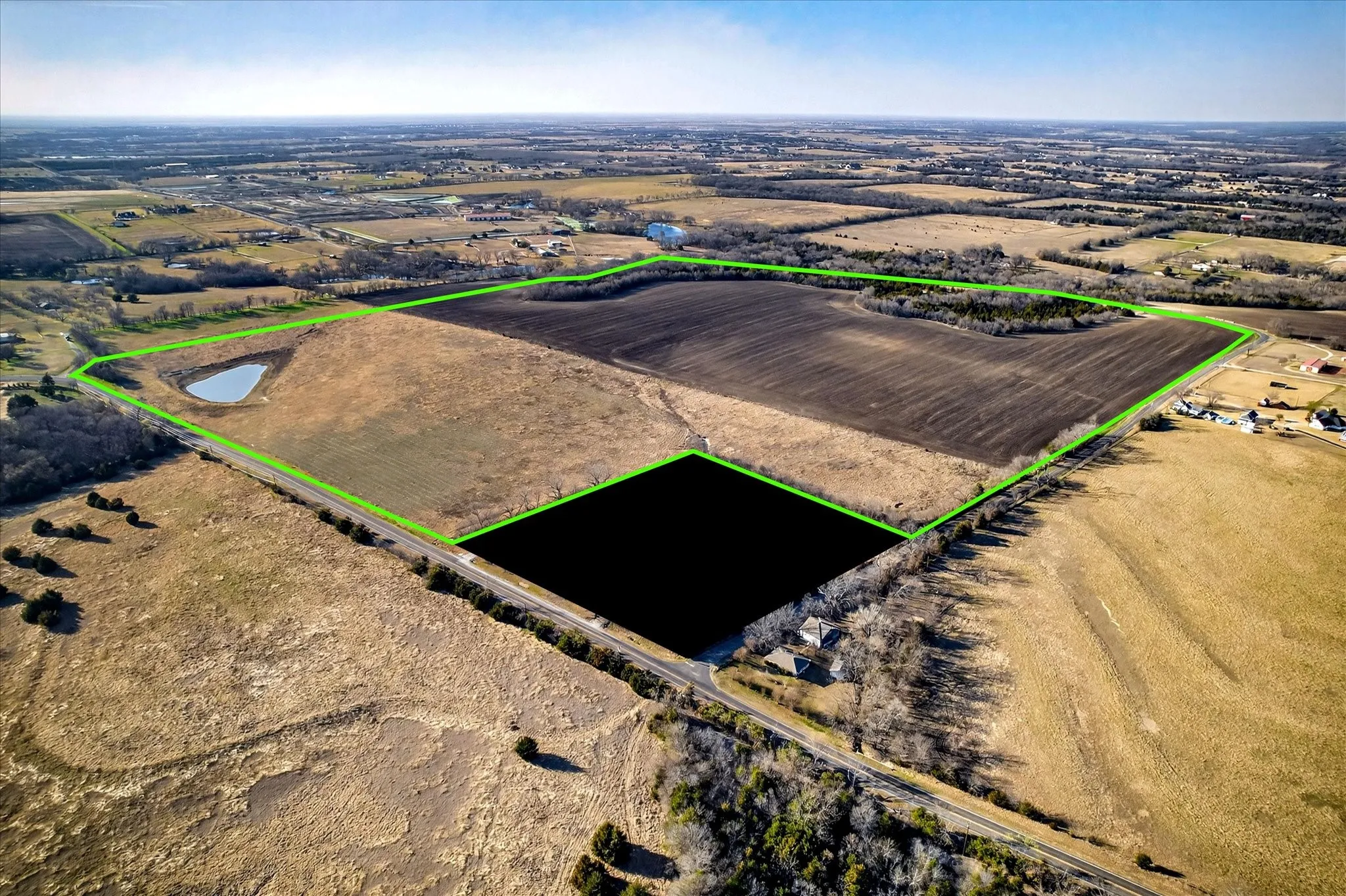 View from where property goes around home on corner with 750' frontage on FM 455 and half mile frontage on Eden Ridge Rd.