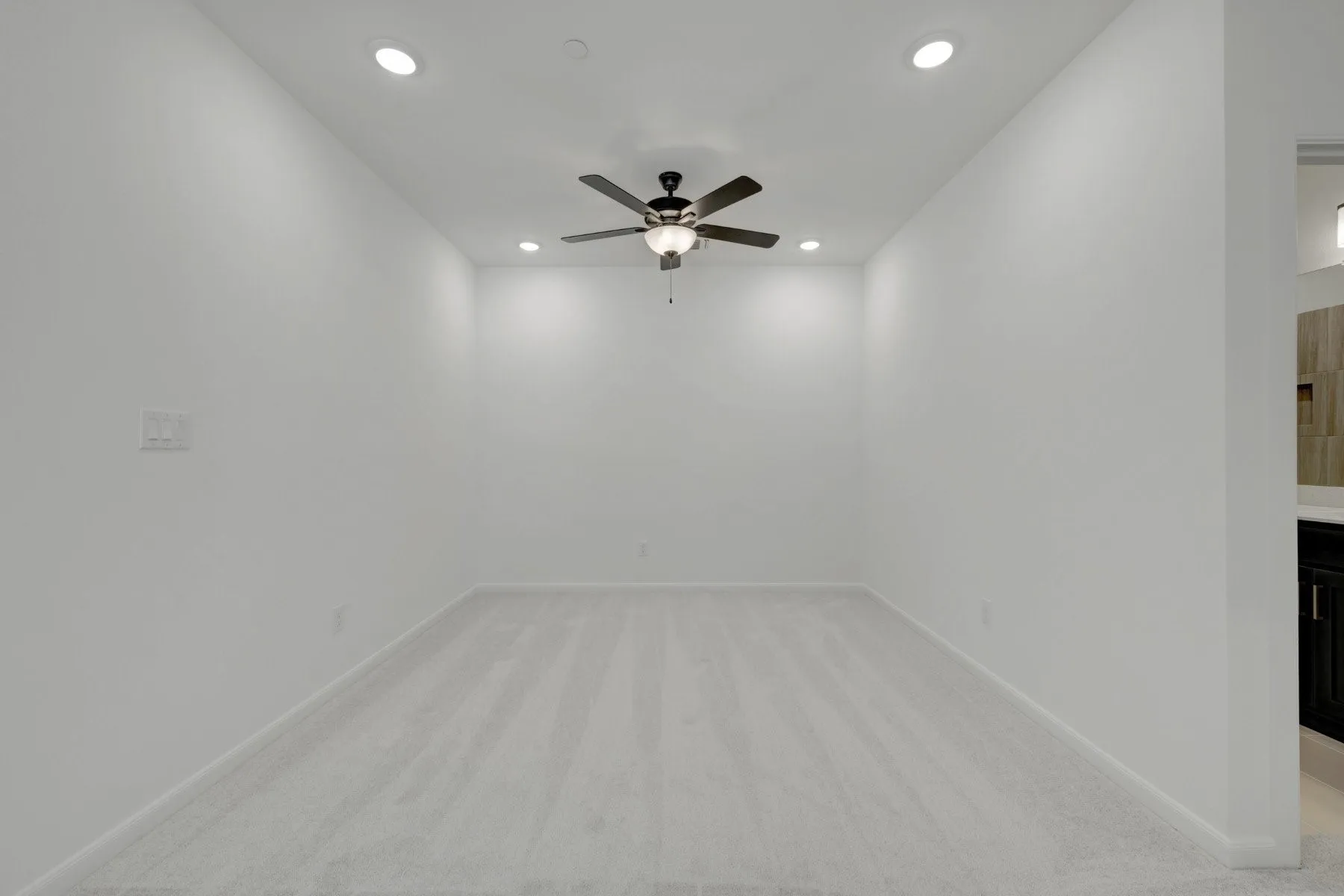 Carpeted room featuring a ceiling fan with integrated lighting and recessed lighting fixtures