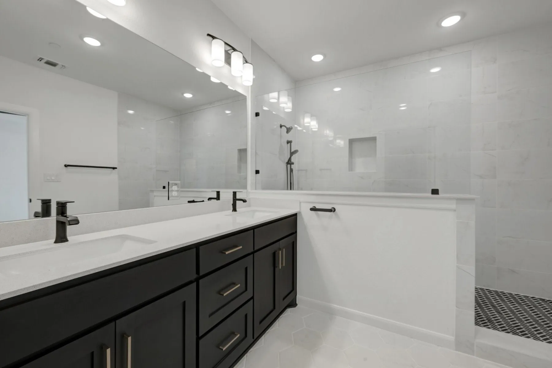 Bathroom featuring a dual vanity with dark wood-finish cabinetry and light-toned countertops
