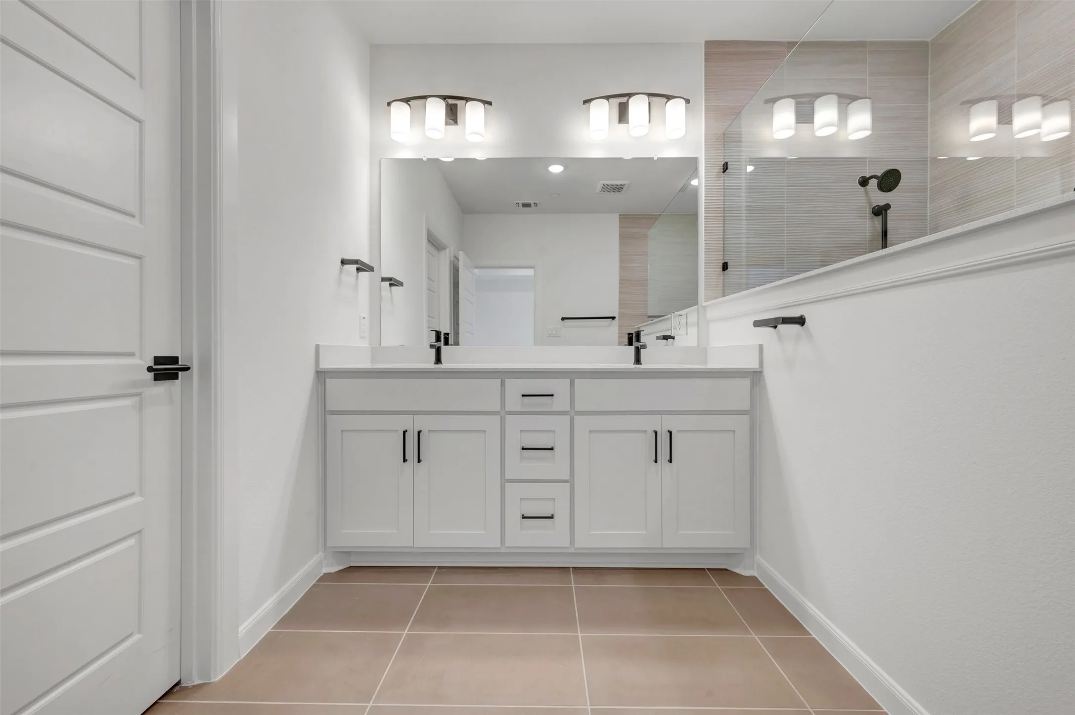 Dual white vanities with quartz-finish countertops and integrated sinks