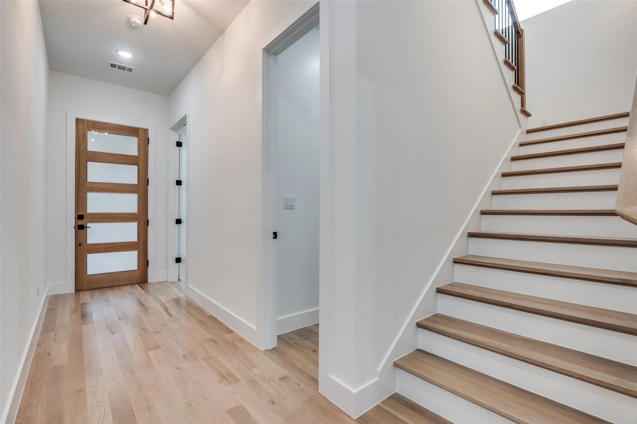 Entrance foyer with light wood finished floors and stairs