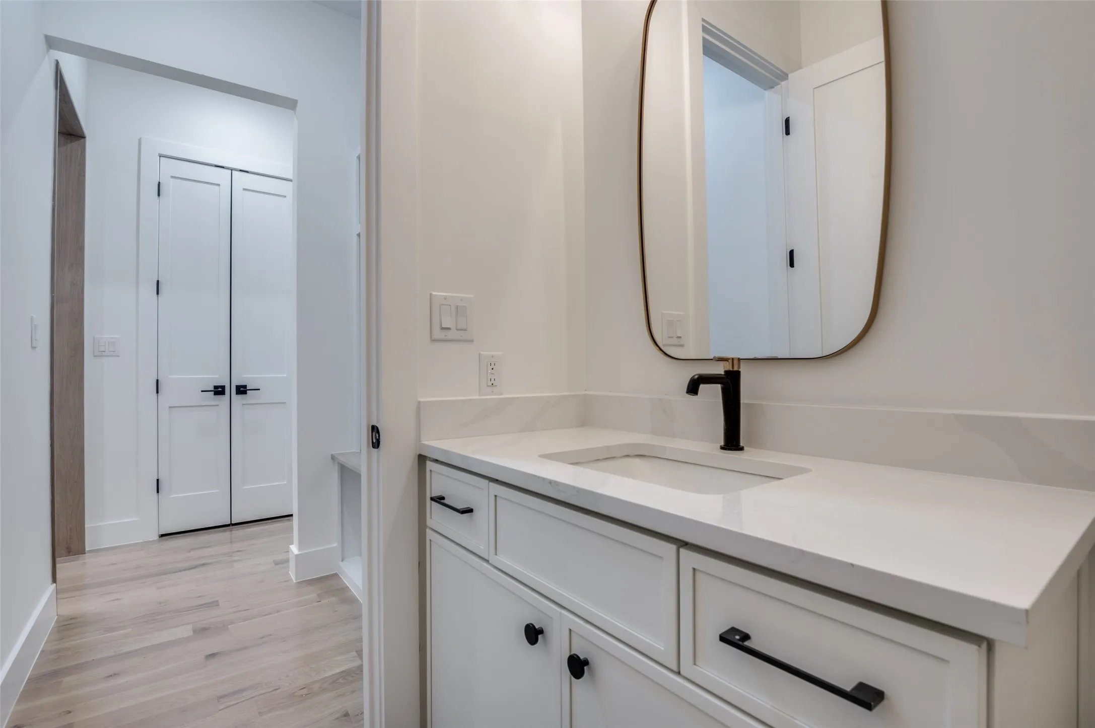 Bathroom featuring vanity and wood finished floors