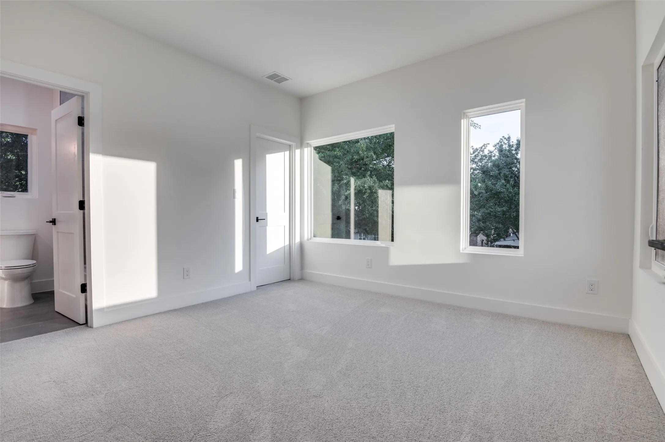 Unfurnished bedroom featuring carpet floors and connected bathroom