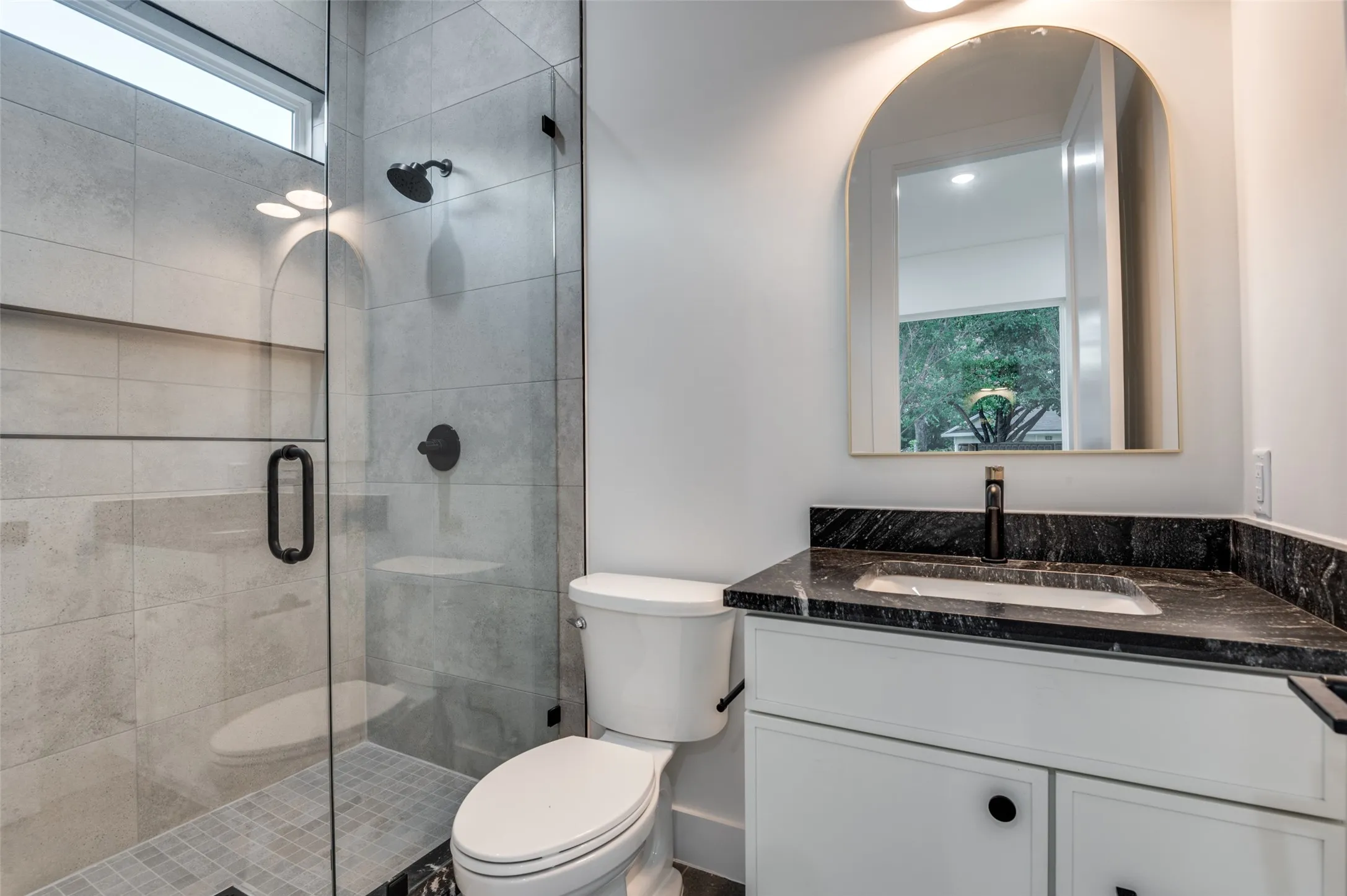 Bathroom with vanity and a shower stall