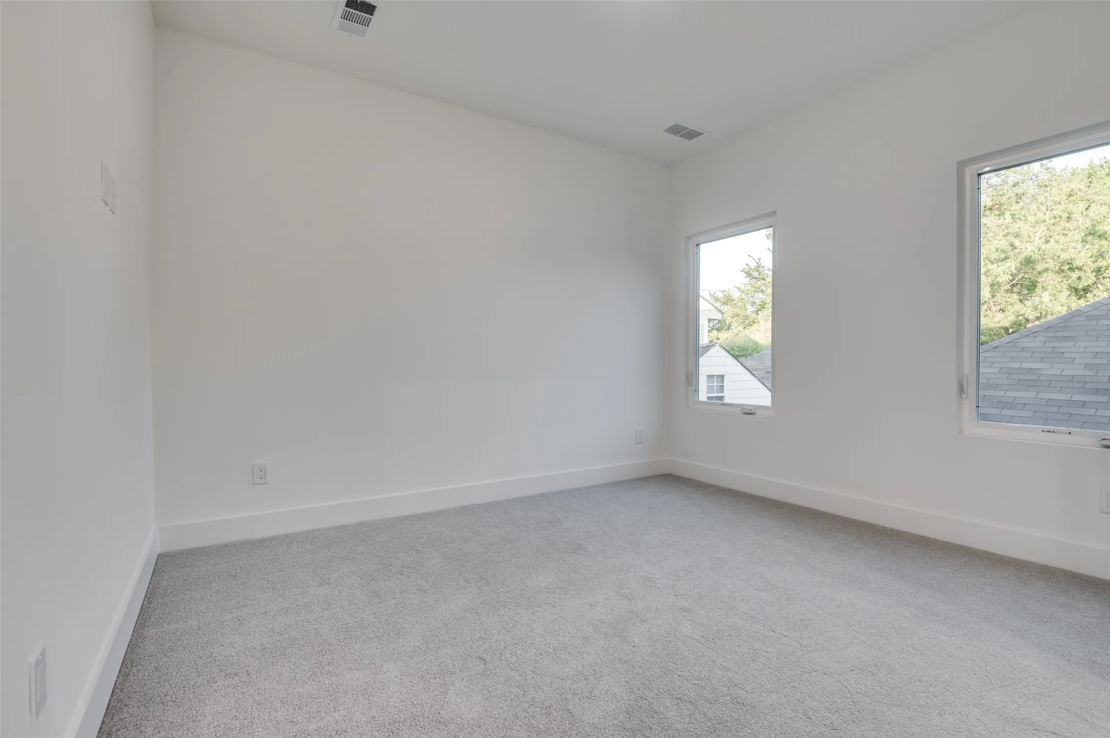 Unfurnished room with light carpet and baseboards