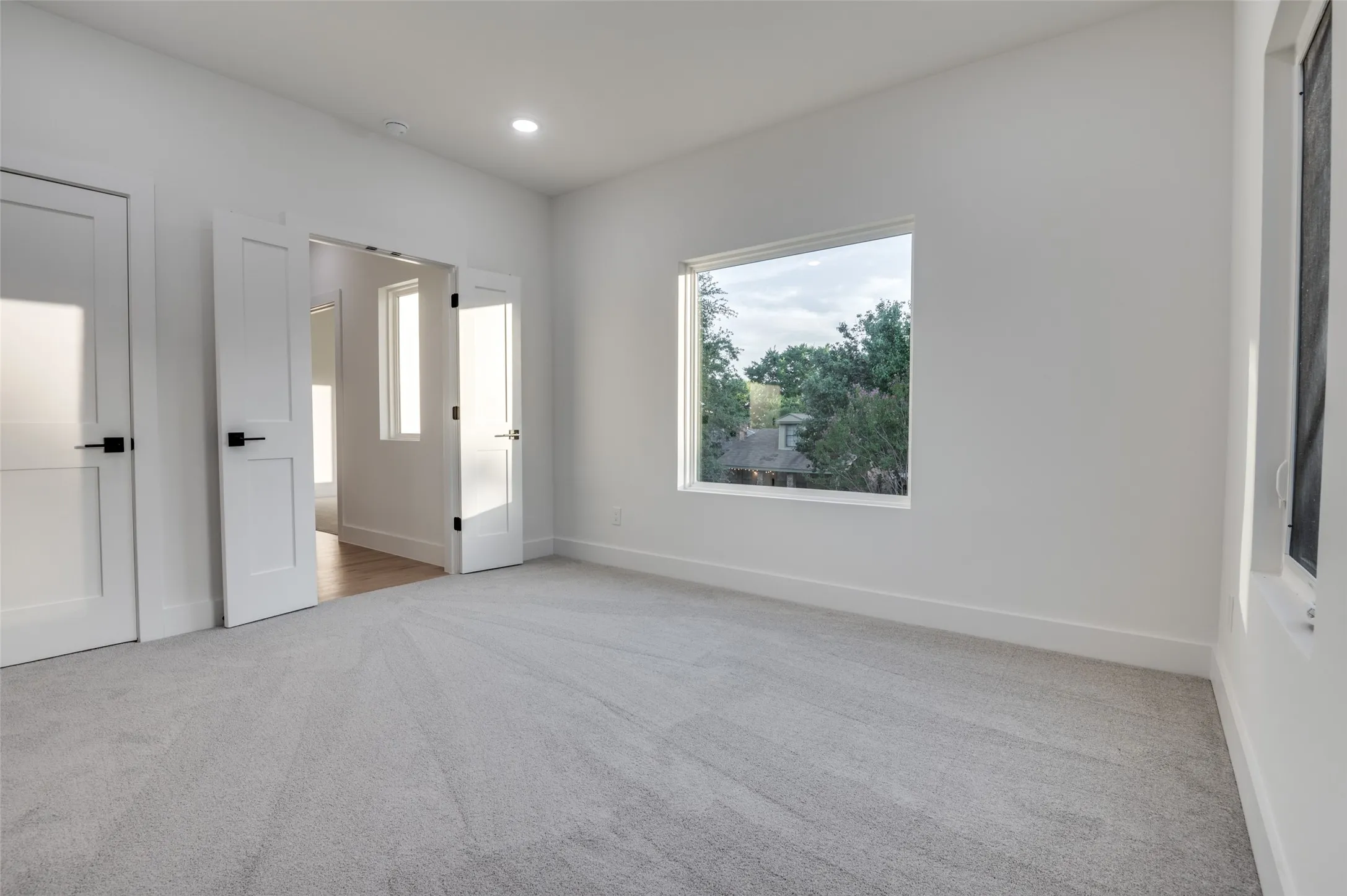 Unfurnished bedroom with carpet floors and recessed lighting