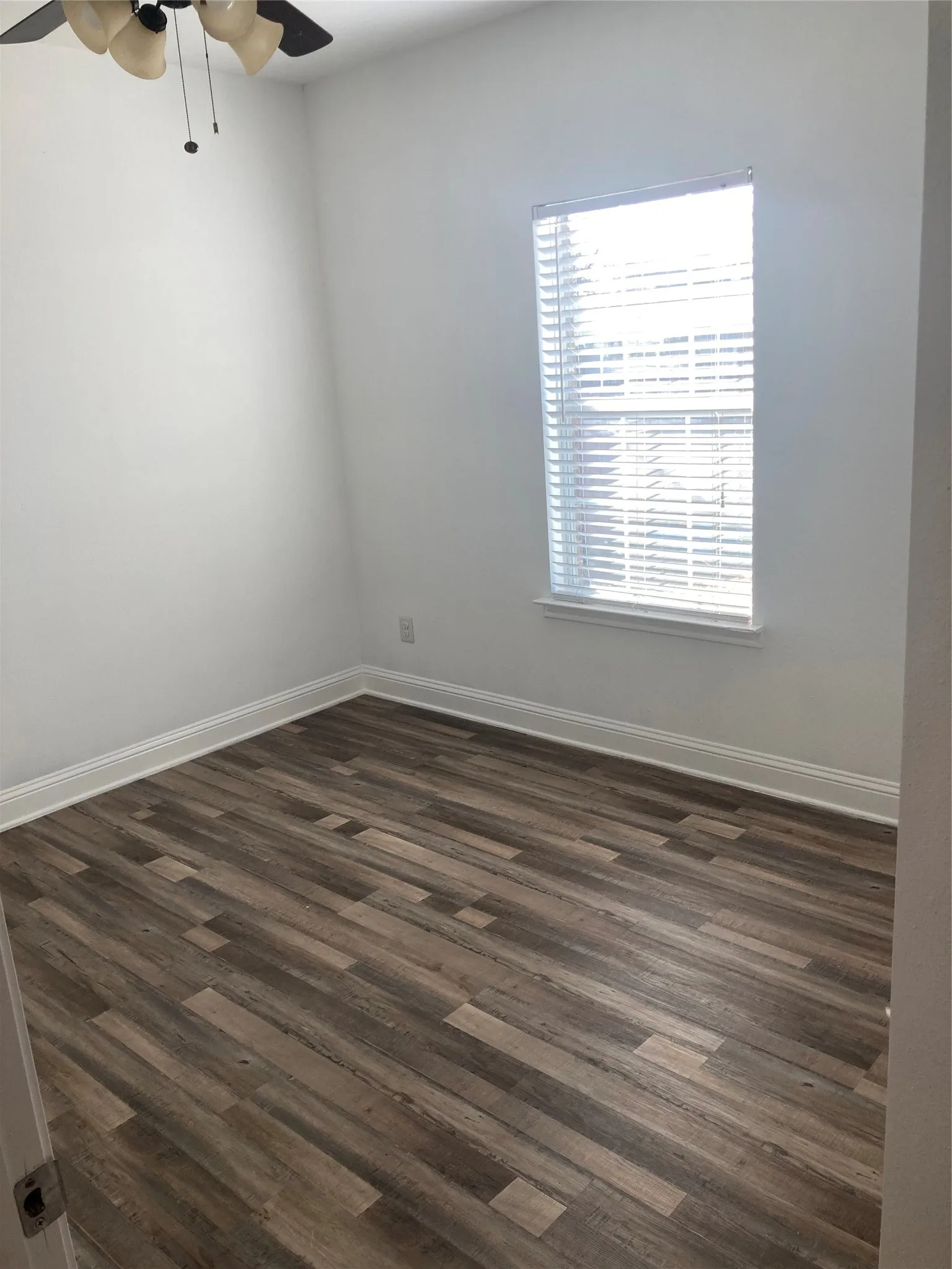 Bedroom #2 has a ceiling fan and new vinyl flooring.