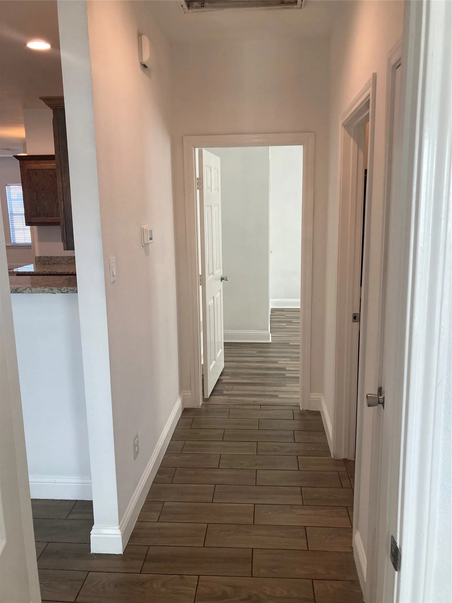 Hallway to secondary bedrooms and bathroom. This is located off of the kitchen and dining area.