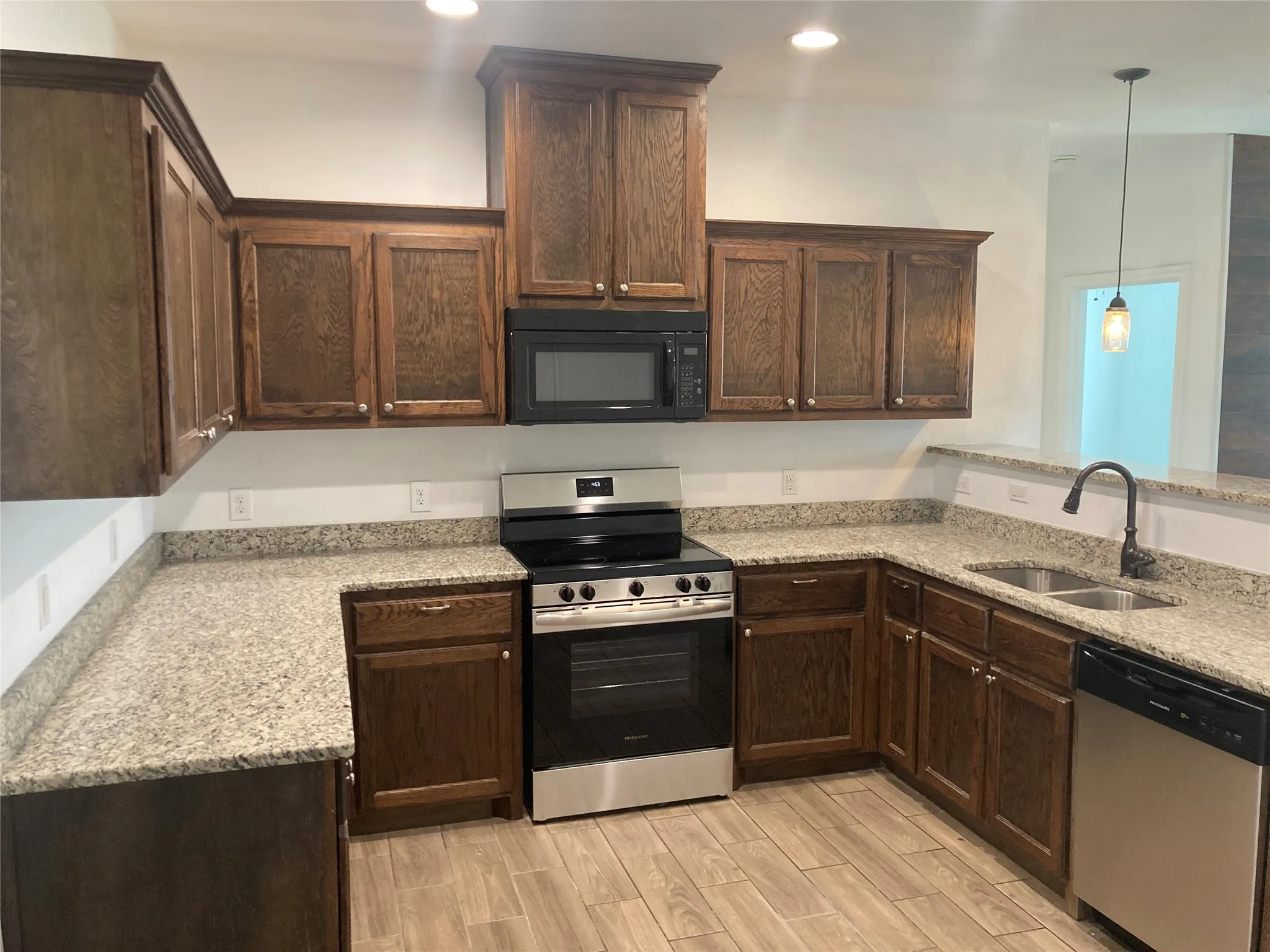 Kitchen has new stainless steel appliances and granite countertops.