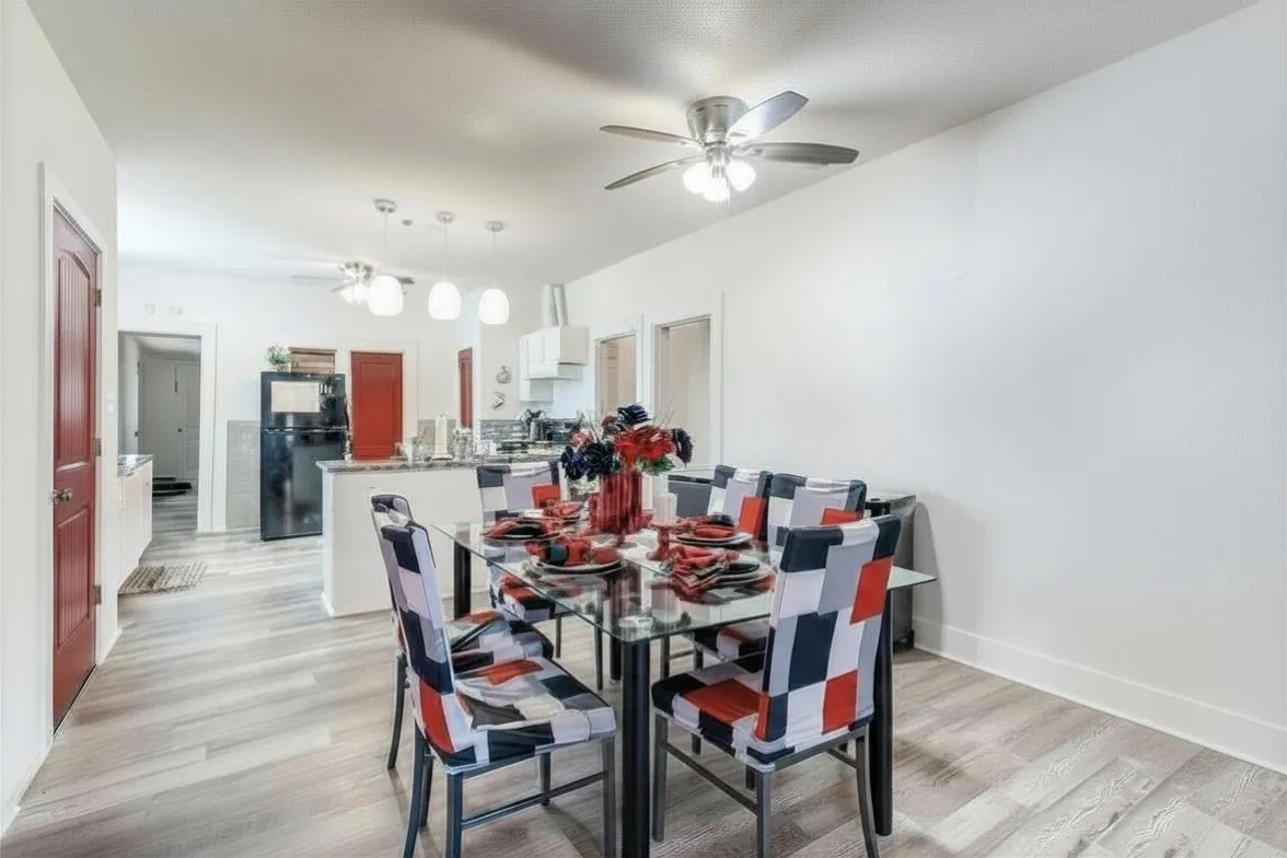 Dining area featuring light wood-type flooring and ceiling fan