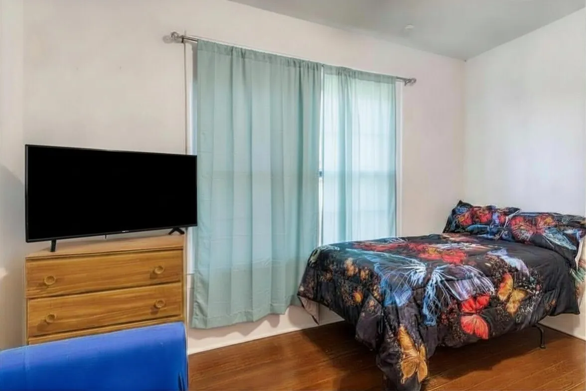 Bedroom featuring dark wood-style flooring