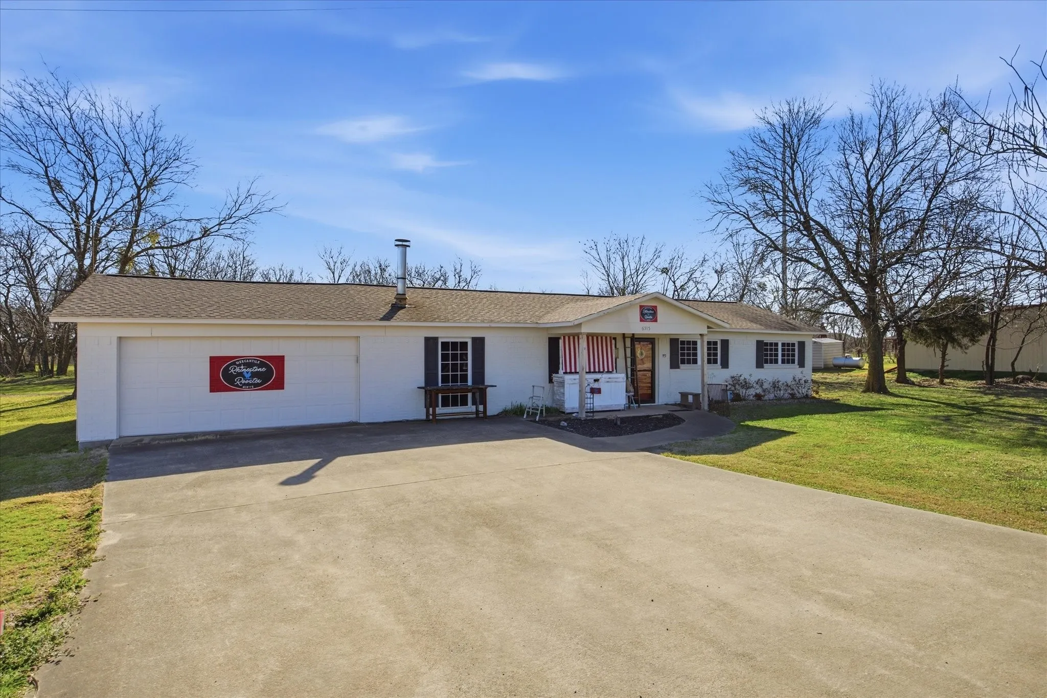 The oversized concrete driveway offers plenty of parking.
