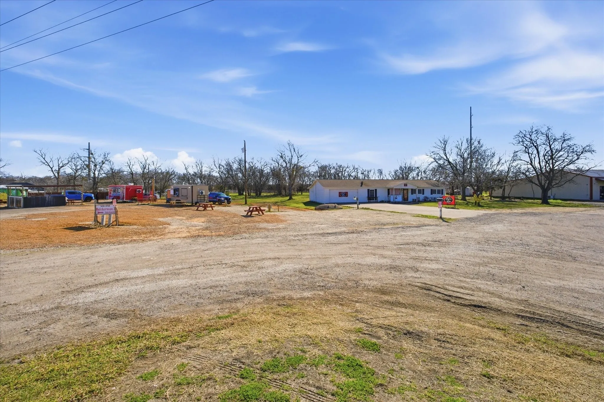 The property includes a 7-space food truck court and 3/1/2 home that is currently leased as a commercial retail shop.