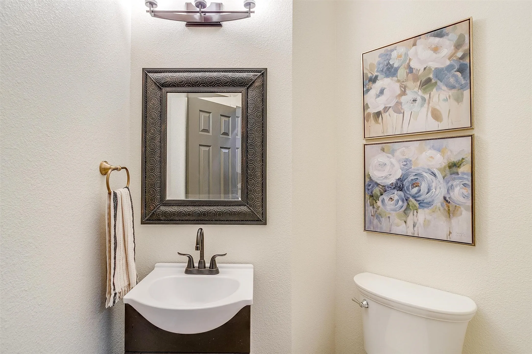 Bathroom featuring vanity and a textured wall