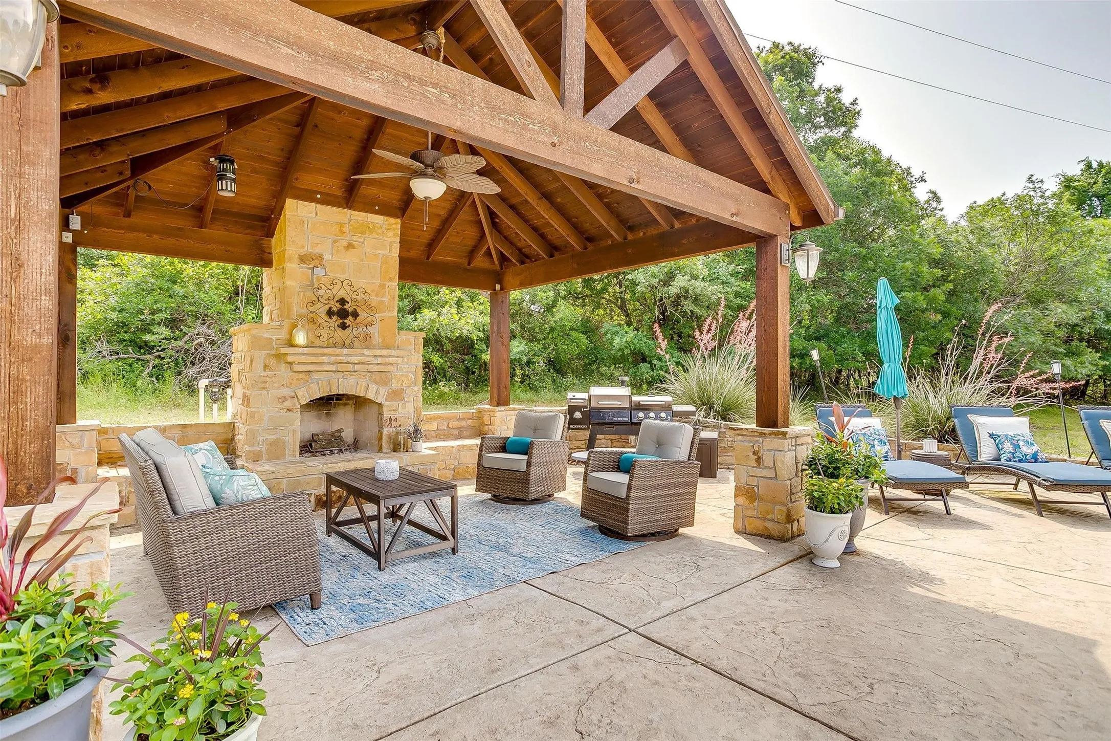 View of patio featuring an outdoor living space with a fireplace and ceiling fan