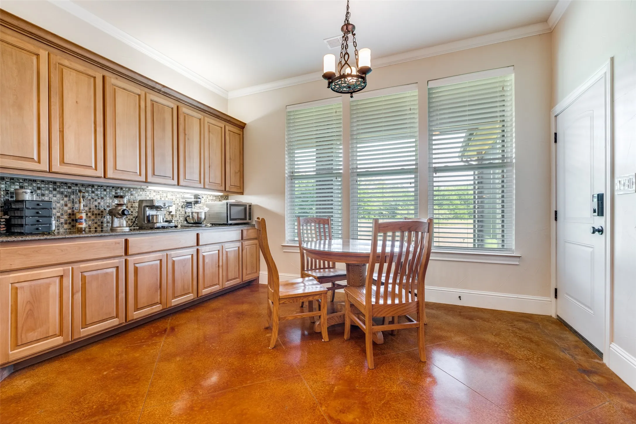 Dining area with crown molding and a chandelier