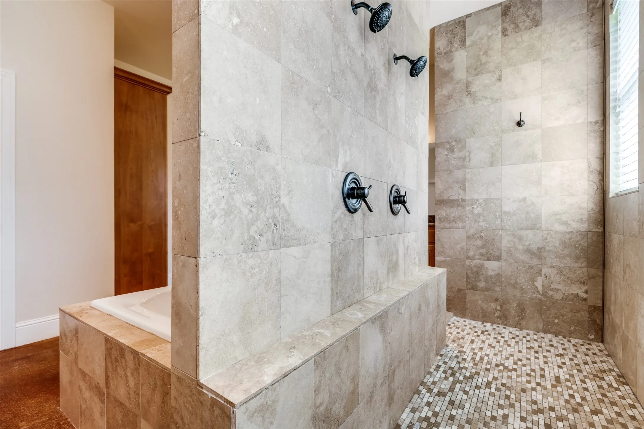 Bathroom featuring a tile shower and a garden tub