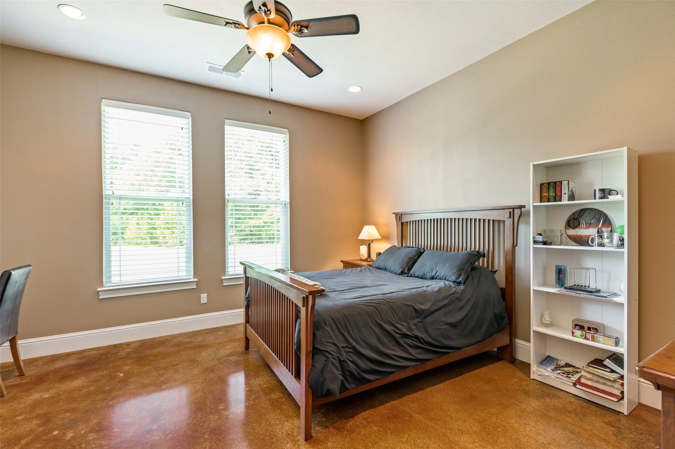 Bedroom featuring concrete flooring, recessed lighting, and ceiling fan