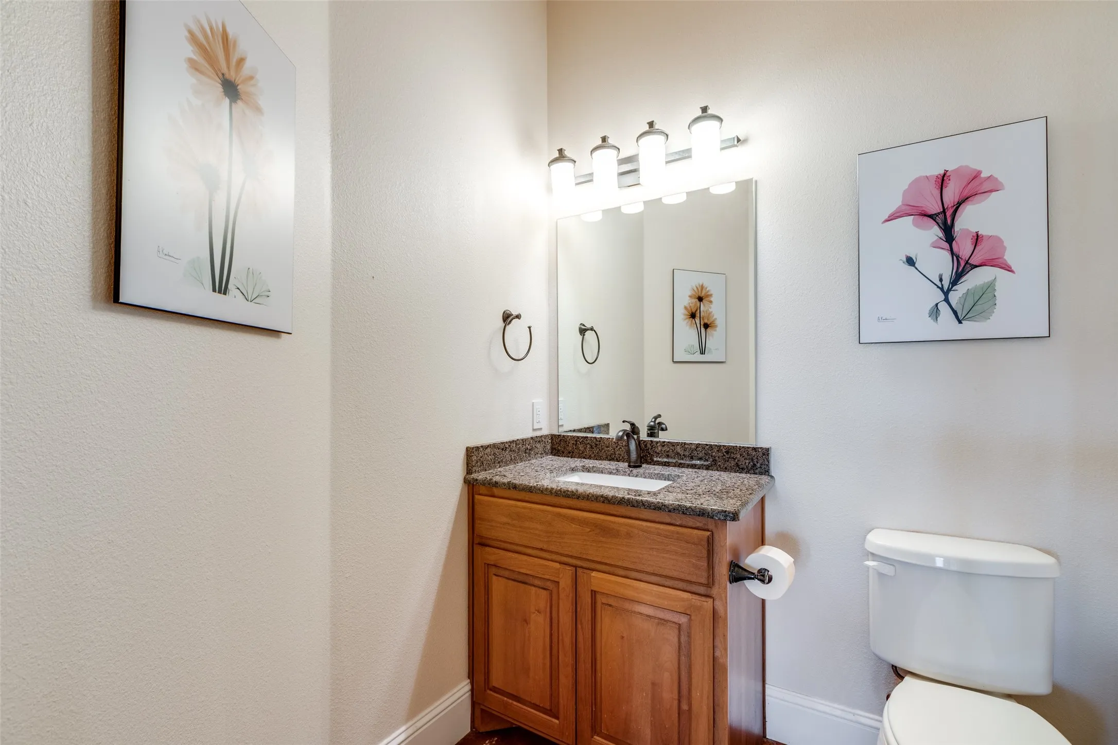 Half bathroom with vanity and toilet