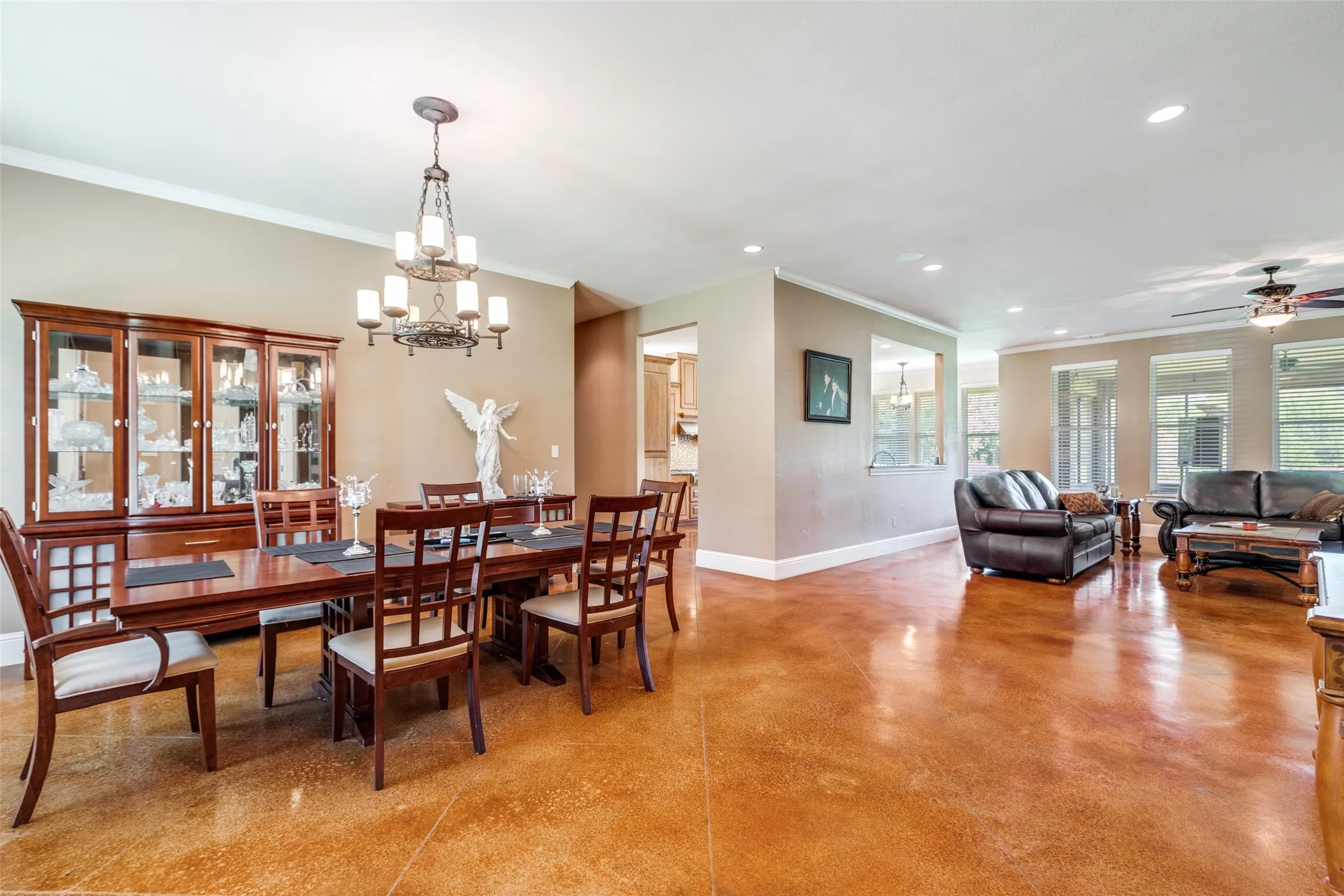 Dining area with ornamental molding, concrete flooring, recessed lighting, a chandelier, and ceiling​​‌​​​​‌​​‌‌​‌‌​​​‌‌​‌​‌​‌​​​‌​​ fan