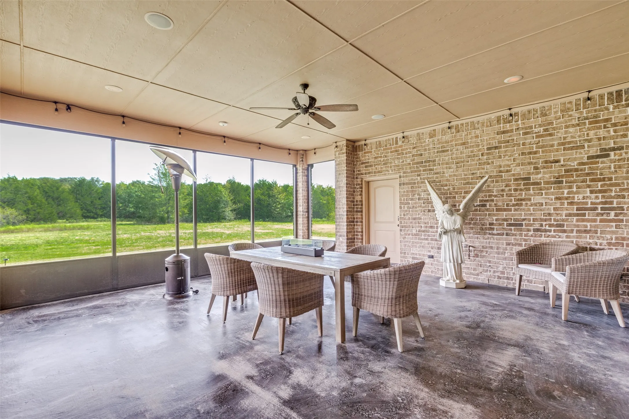 Sunroom / solarium with plenty of natural light and view of scattered trees