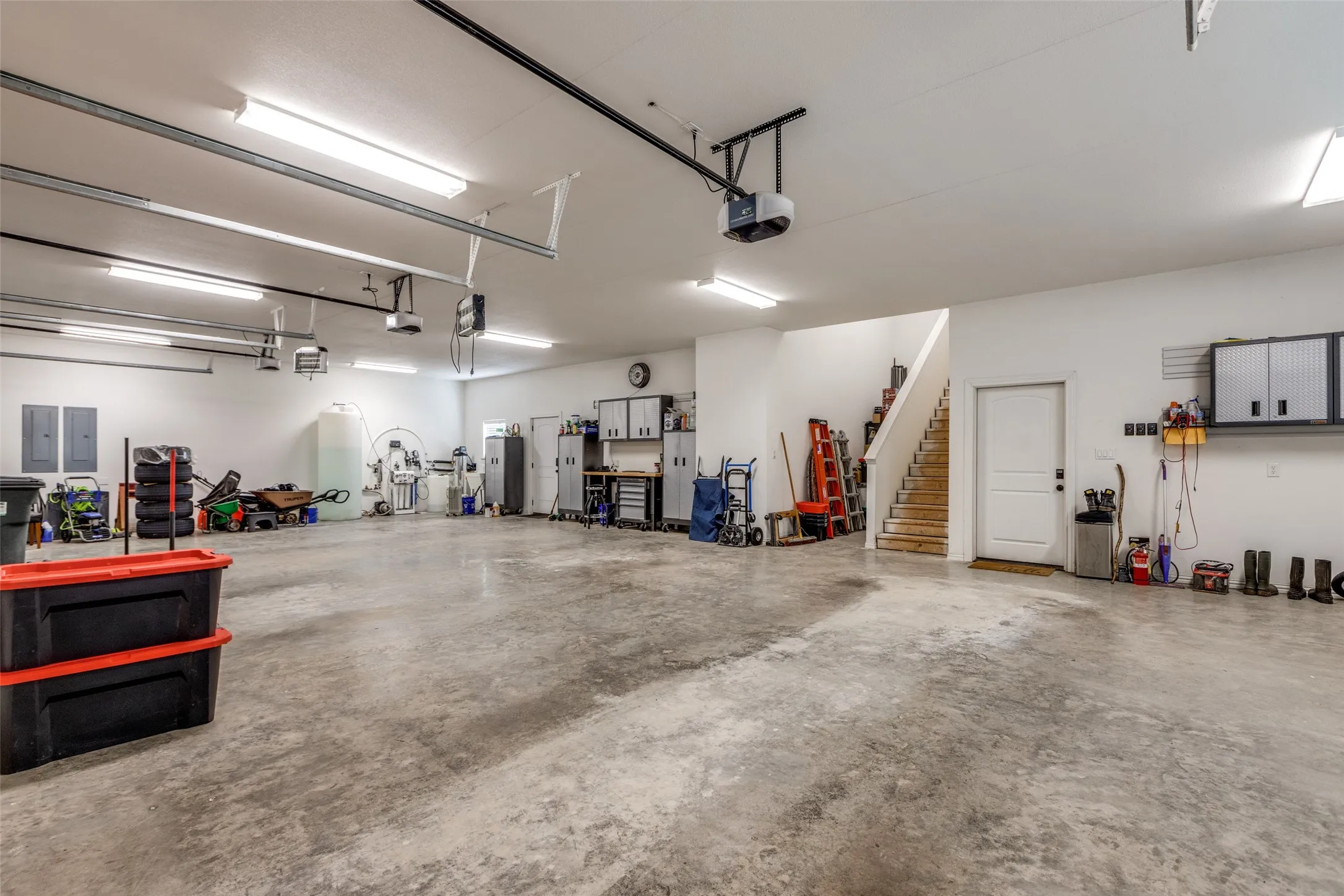 Garage with electric panel and a garage door opener