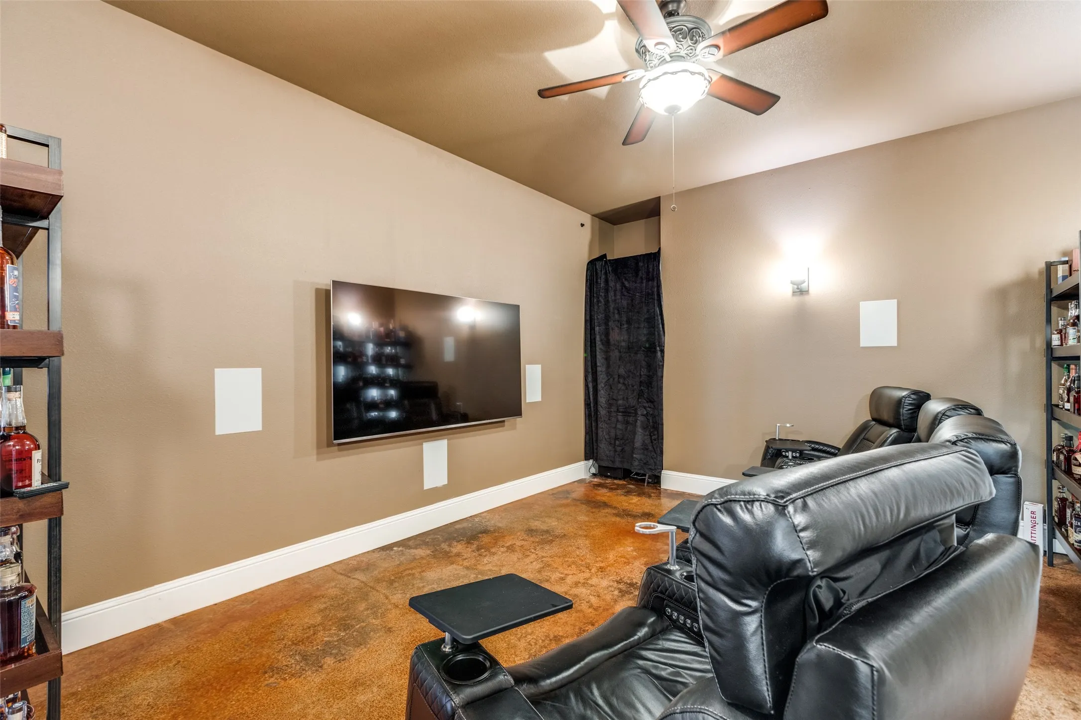 Cinema room with baseboards and ceiling fan