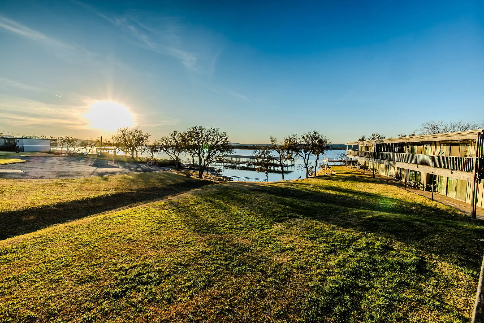 Sunset over the lake with a glimpse of the next door units in the F building of The Landing Condos.