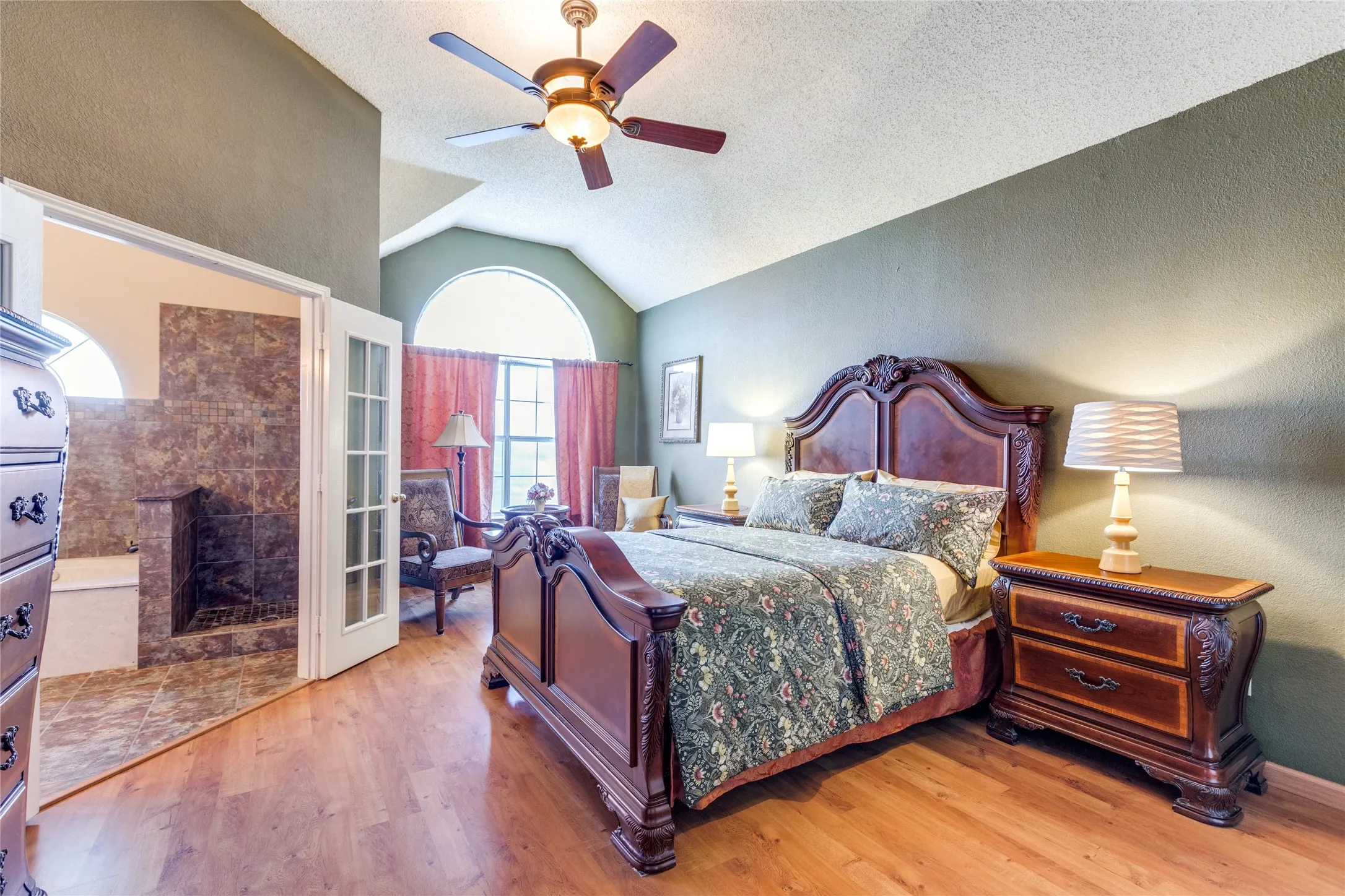 Primary bedroom with sitting area and two walk-in closets.