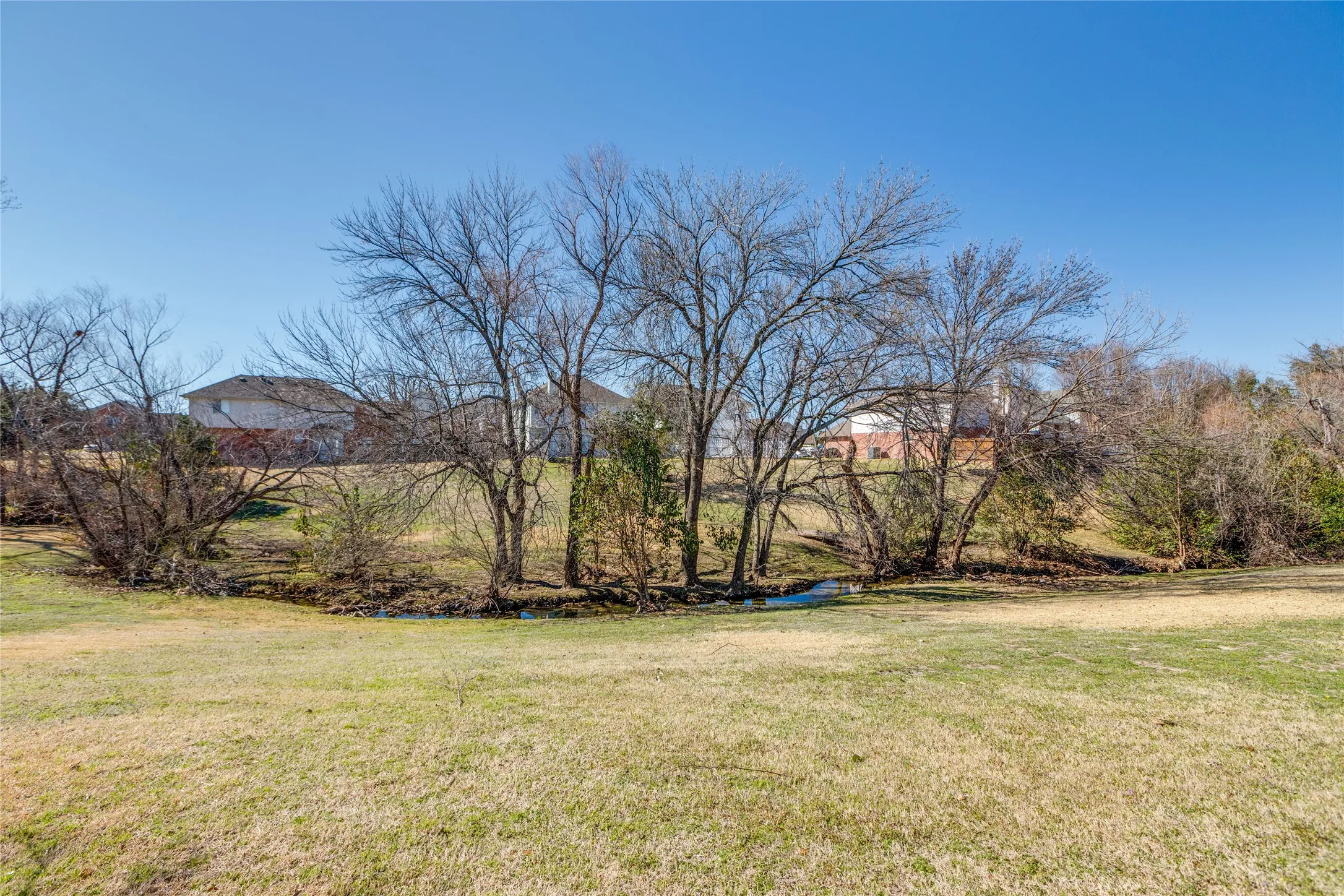 Huge greenbelt with creek directly behind home with access from backyard gate!