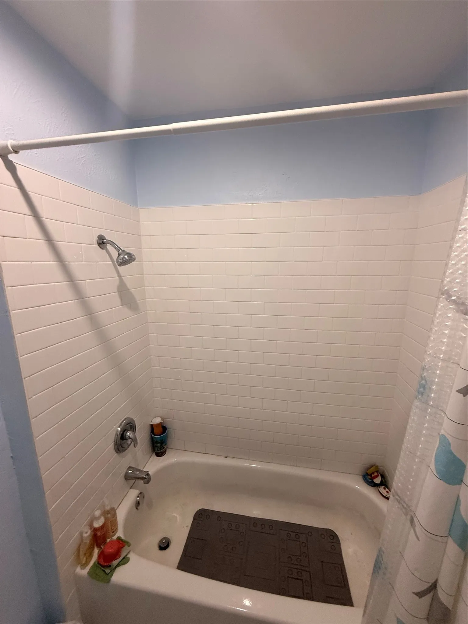 Bathroom featuring shower / bath combination with curtain