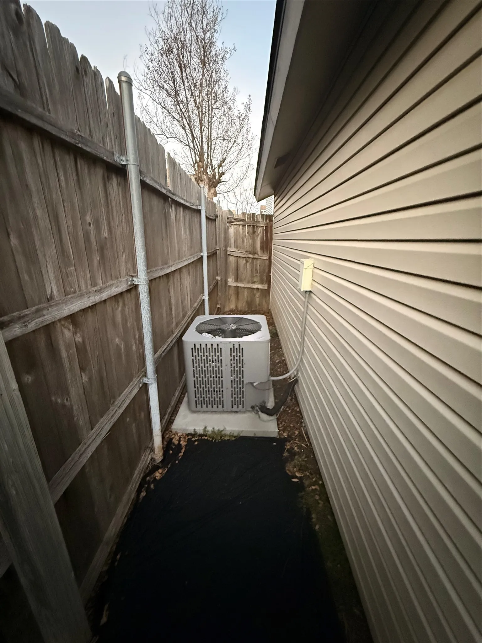 View of home's exterior featuring a central air condition unit and a patio area