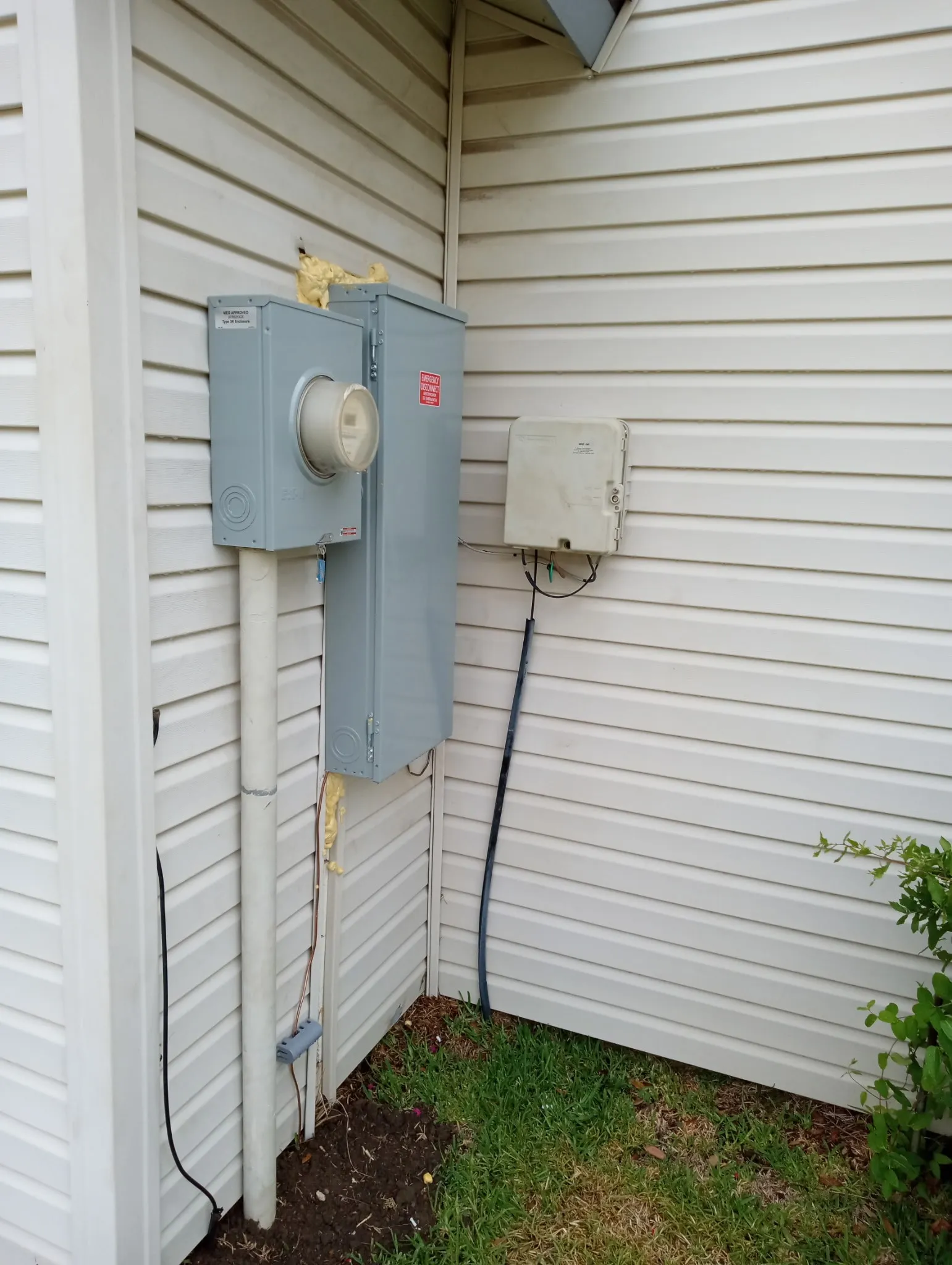 Exterior utility area featuring horizontal siding, an electrical meter box, and a service panel