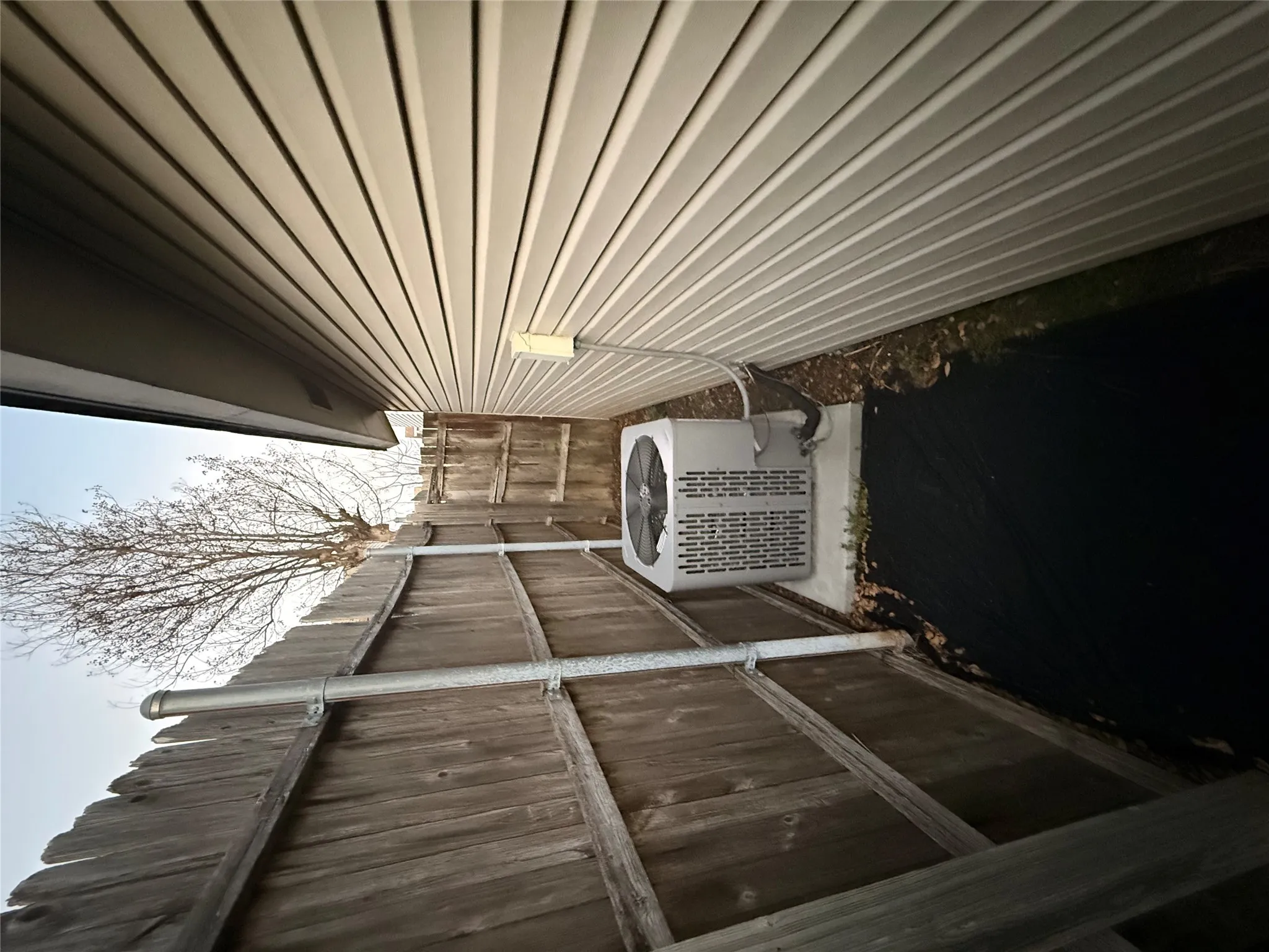 View of property exterior featuring a central AC unit and a patio