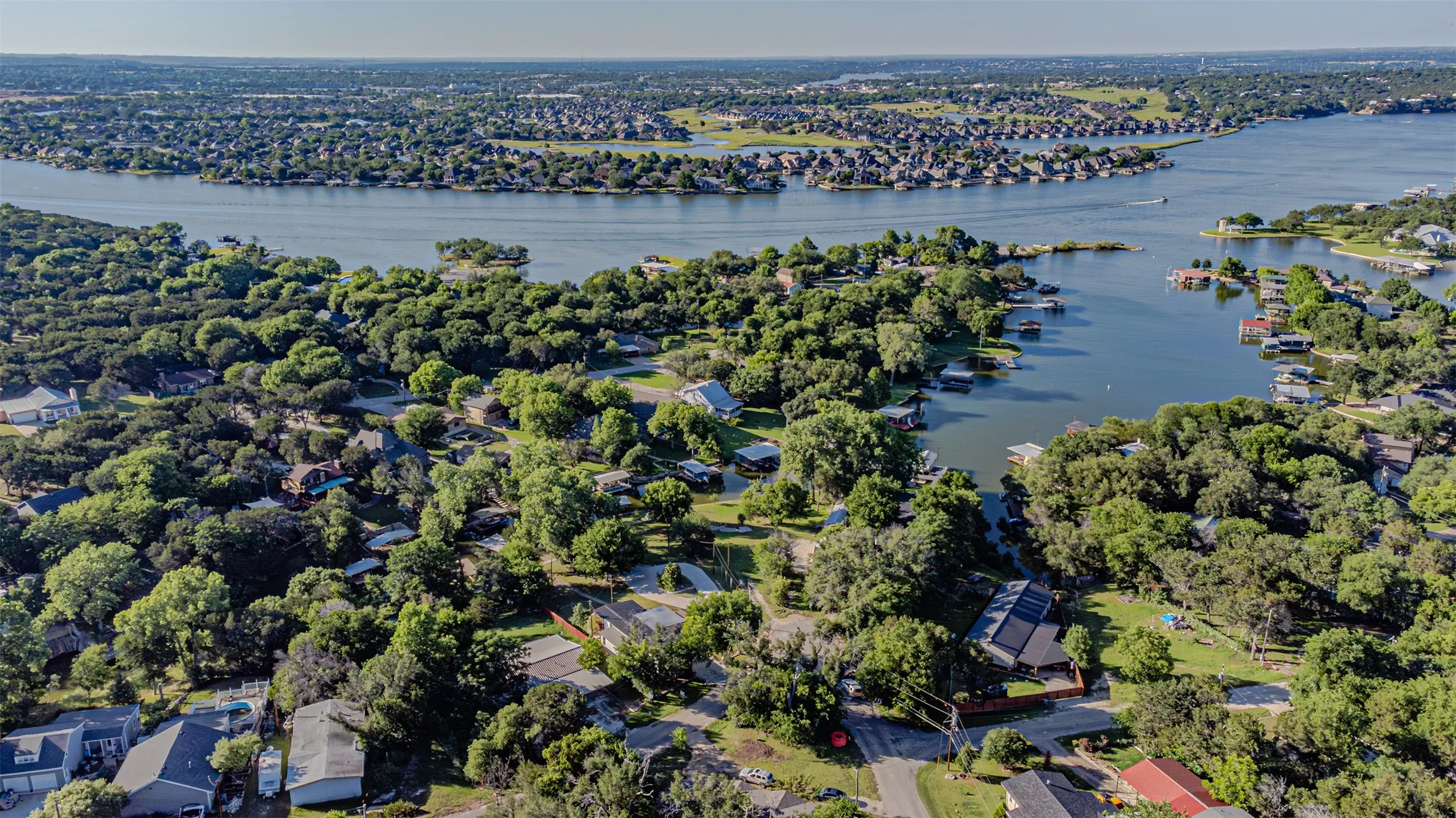 Aerial perspective showcasing a residential area bordered by a large body of water