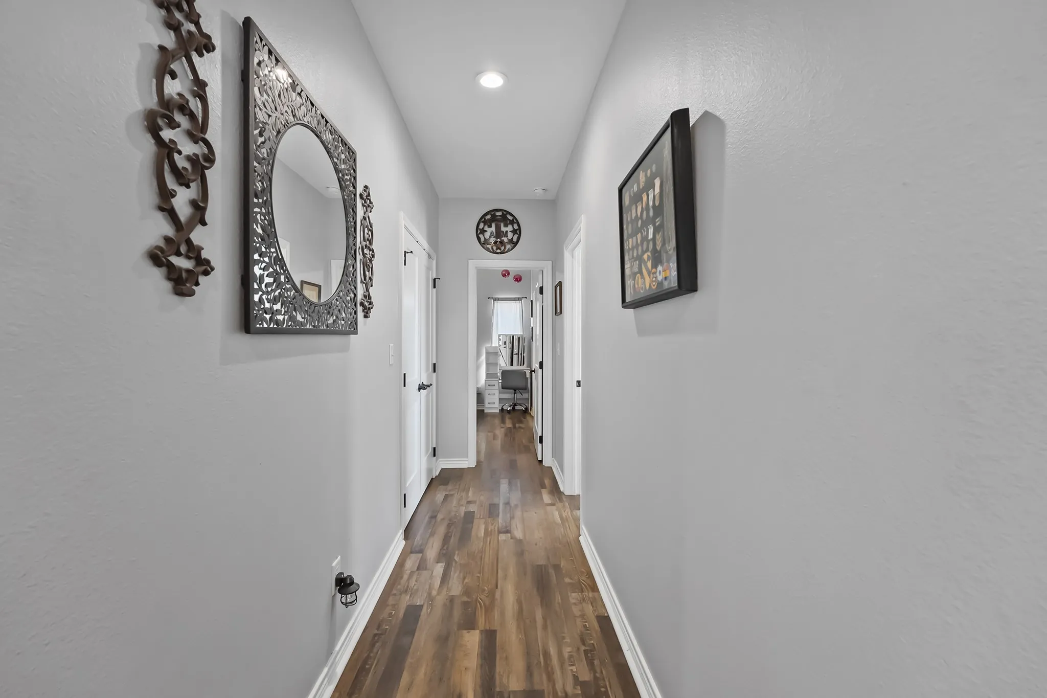 Corridor featuring baseboards and dark wood-style floors