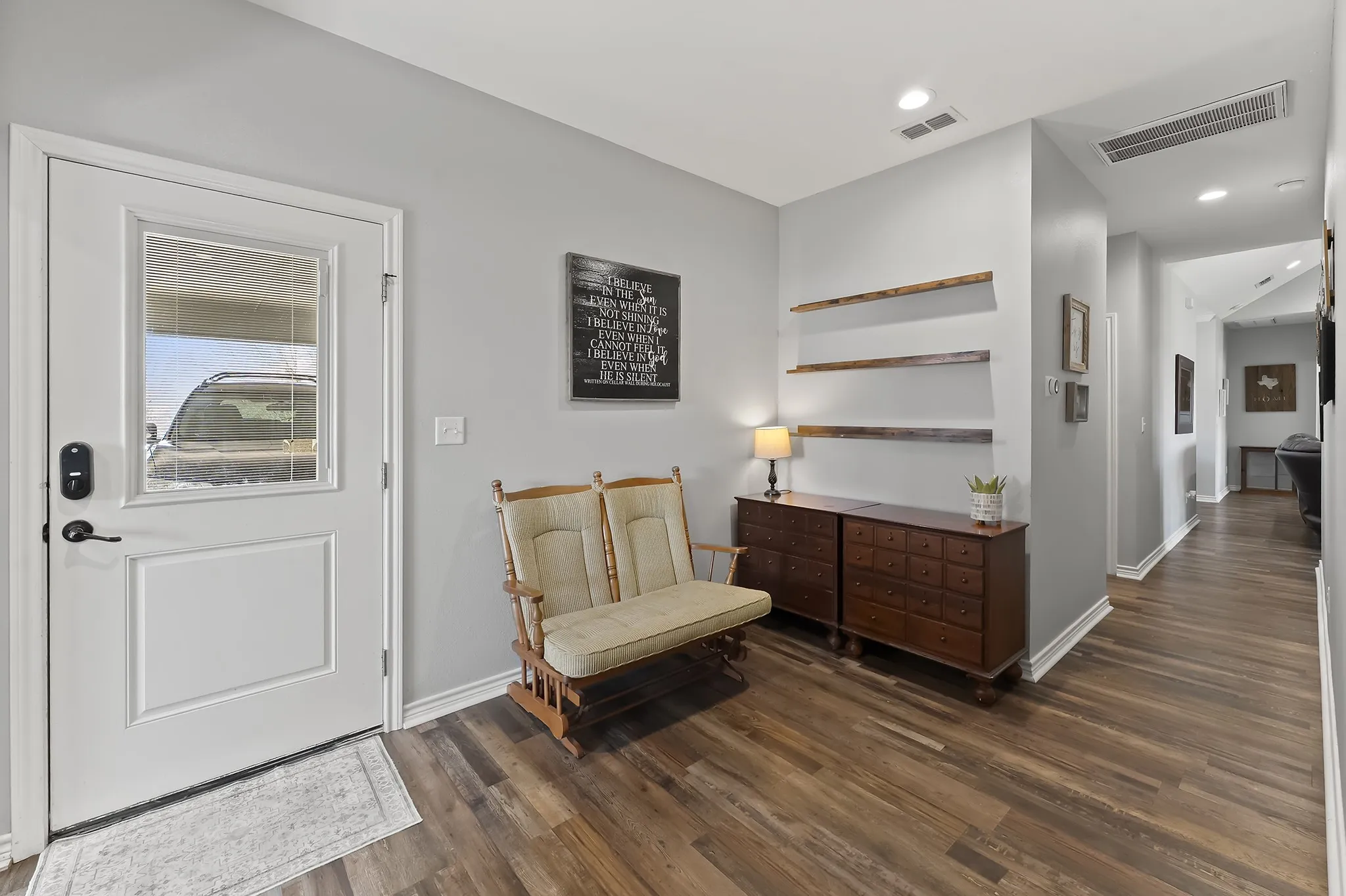 Foyer entrance with dark wood finished floors and recessed lighting