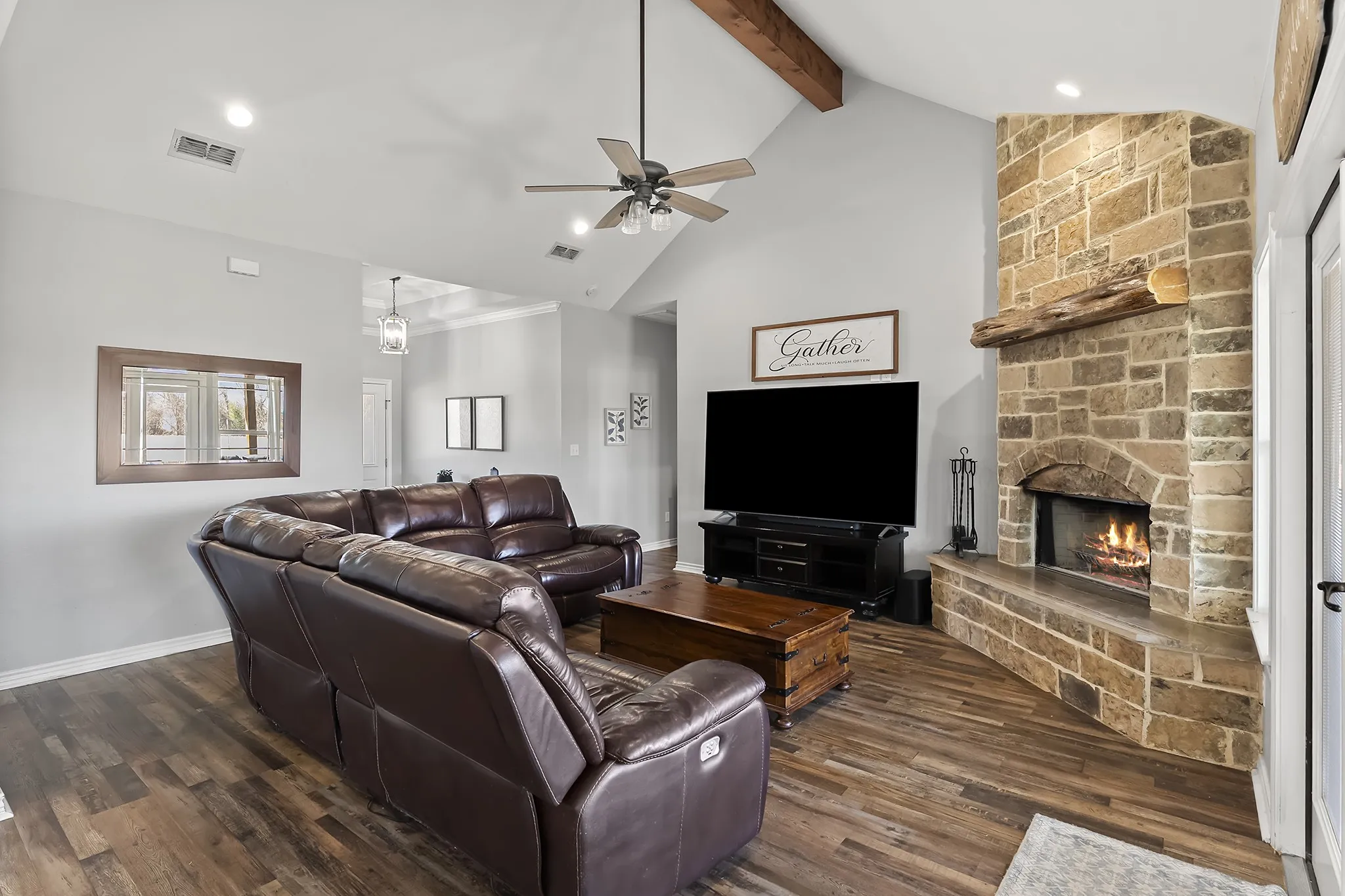 Living room with a ceiling fan, a fireplace, dark wood-style floors, and recessed lighting