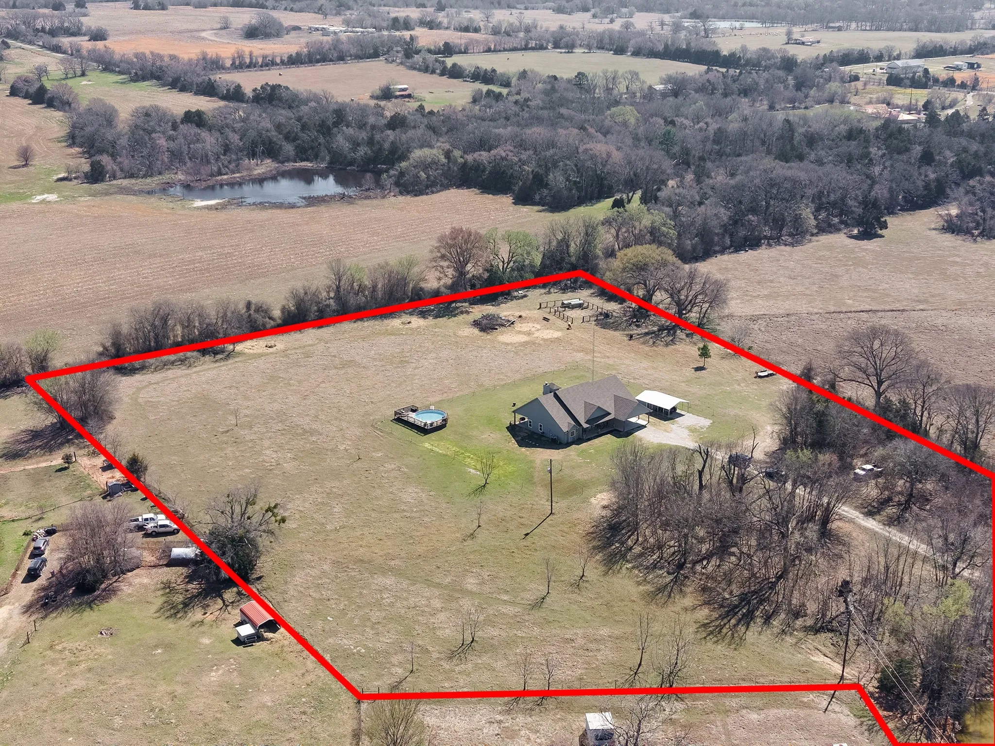 Aerial view of sparsely populated area with property boundaries highlighted and a large body of water